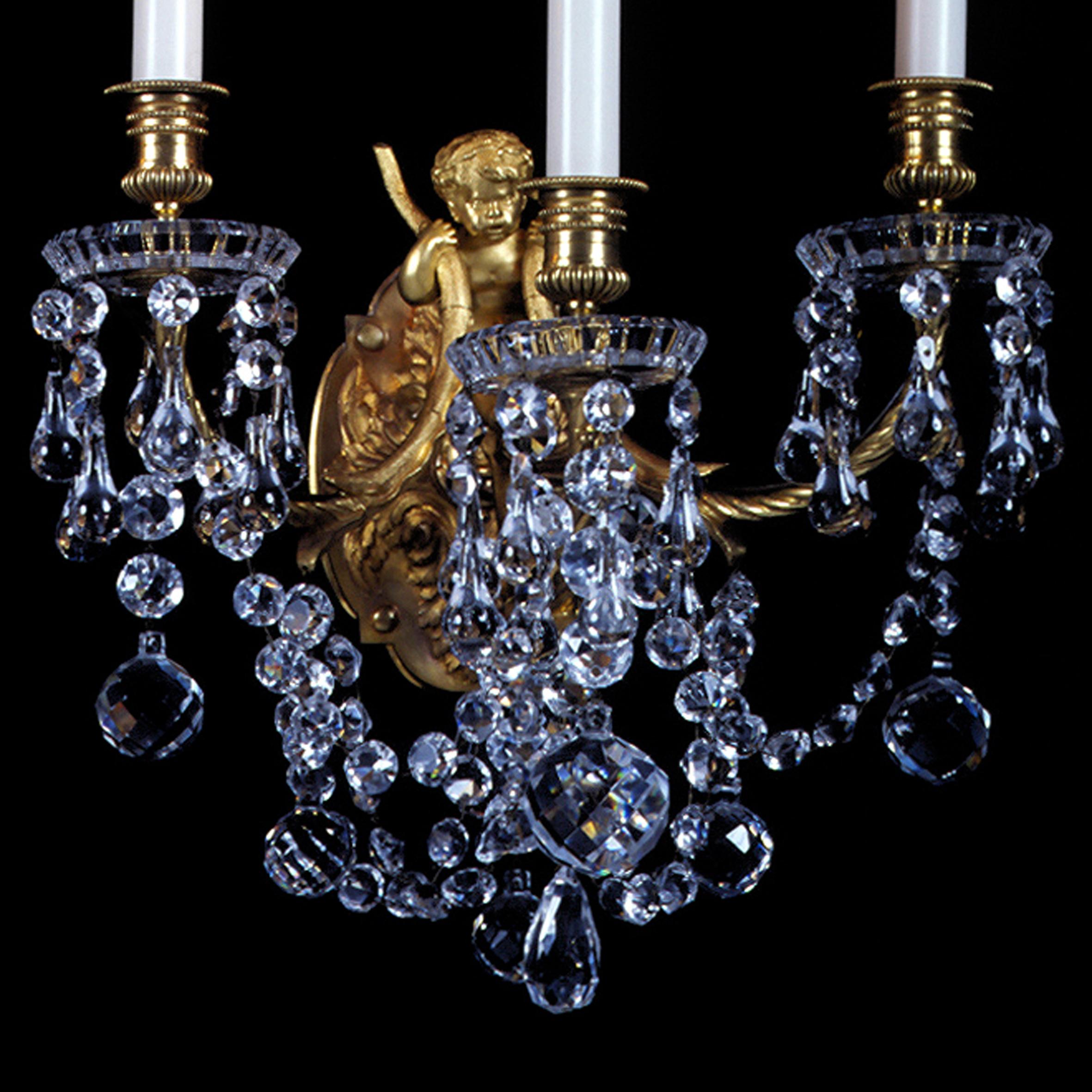 A fine pair of Louis XVI Style Gilt-Bronze and Moulded-Glass Three-Light Cherub Wall Appliqués by La Compagnie des Cristalleries de Baccarat.

French, circa 1890. 

Glass drip pans stamped ‘BACCARAT’.

Each appliqué having an oval acanthus