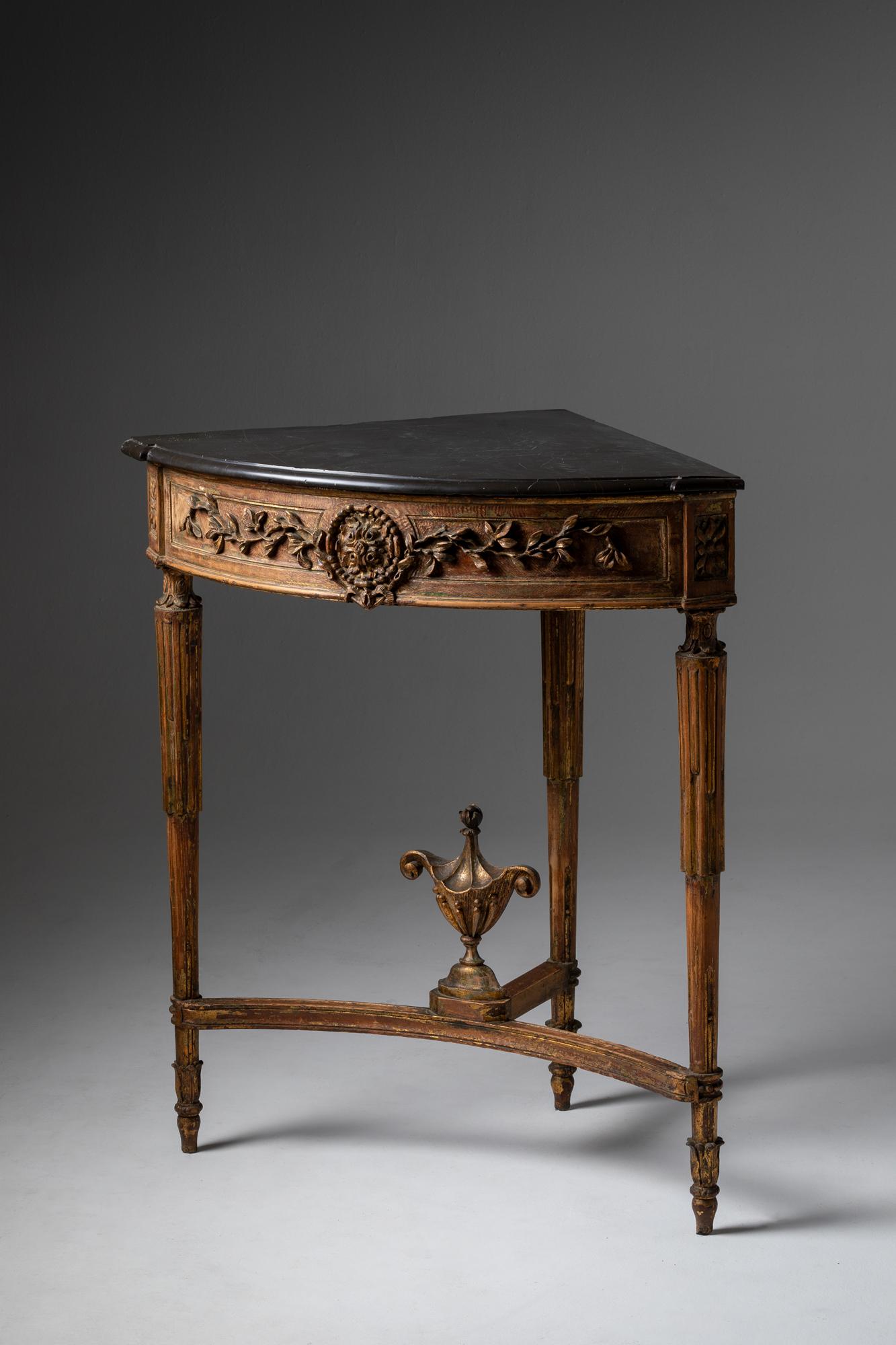 Pair of Louis XVI style corner tables.
Carved wood, with traces of ancient gold and black marble tops. 
Portugal 19th century.
Made by the french interior design, Lucien Donnat, who lived in Portugal since he was a child.