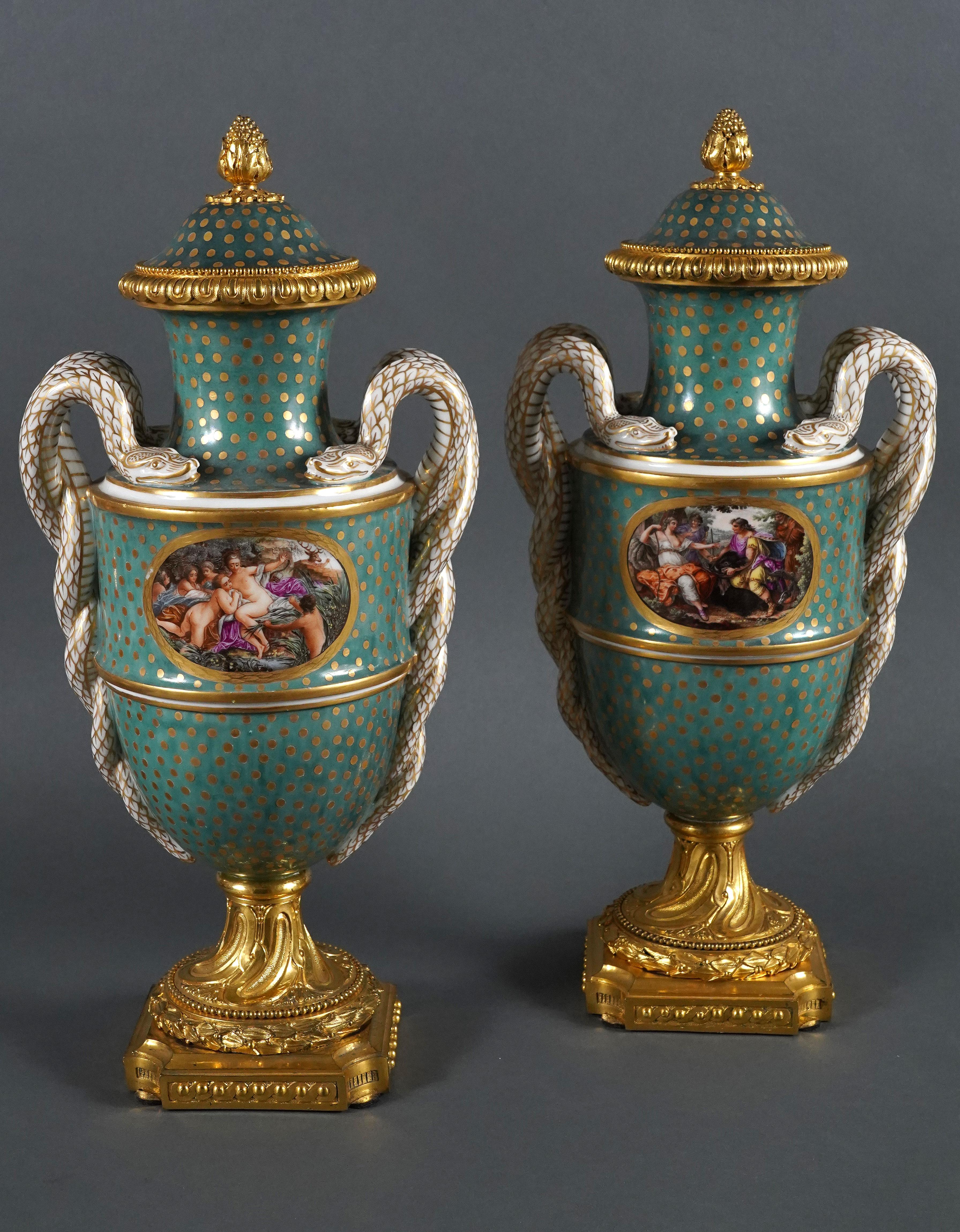 Pair of Louis XVI style baluster shaped covered vases attributed to Samson & Cie, made in porcelain with green background and gold dots, flanked by two applied handles made of white and gold double-coiled snakes. The bodies are finely painted with