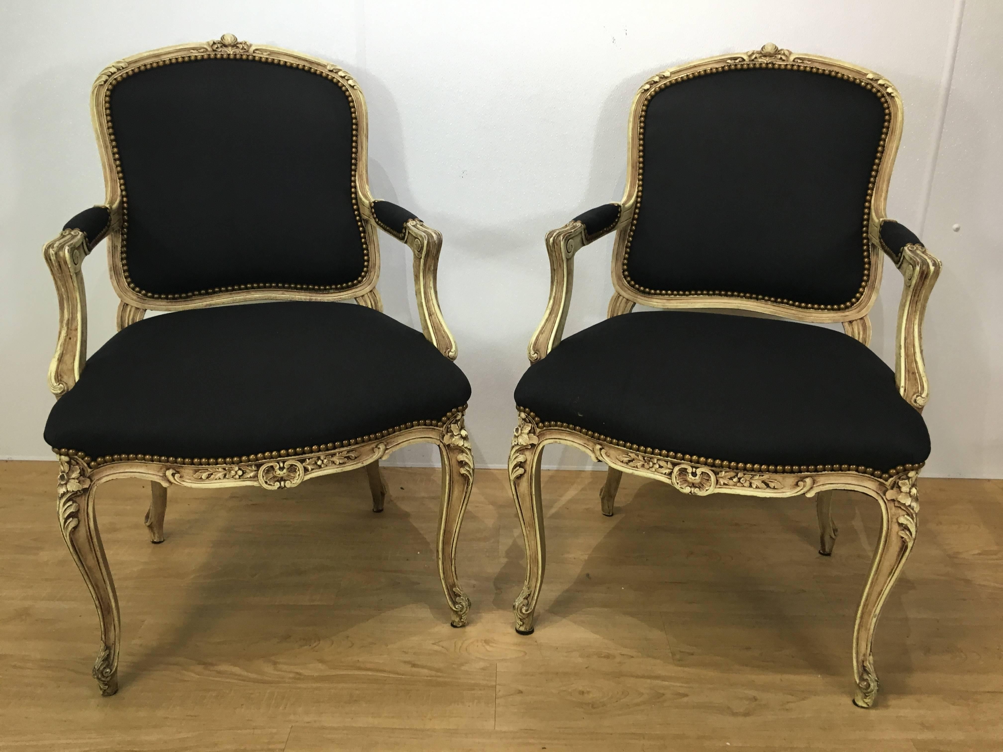 Pair of style Louis XVI armchairs or fauteuils each one finely carved cream painted frames with new upholstery.