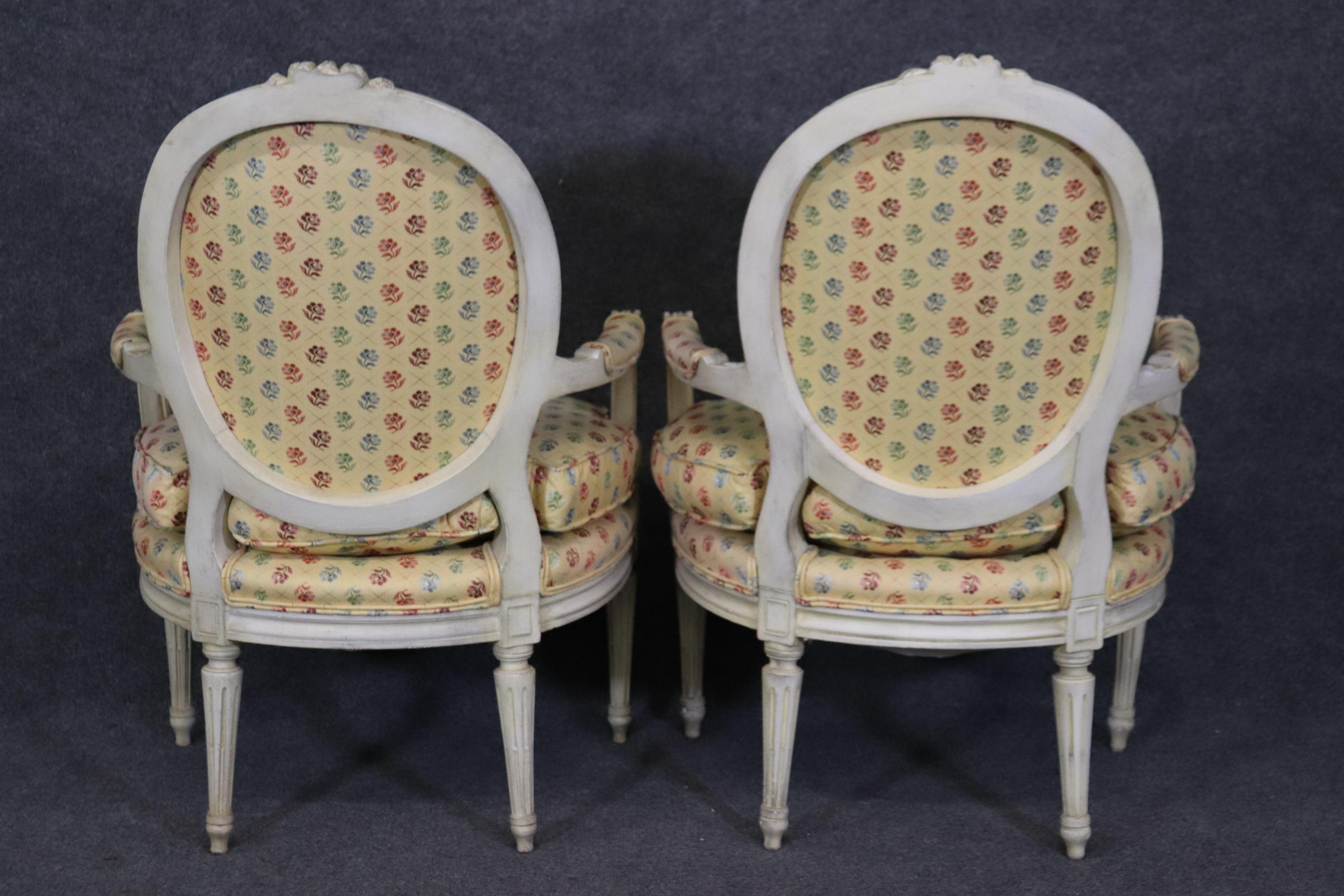 Carved Pair of Louis XVI Style Creme Paint Decorated Armchairs For Sale