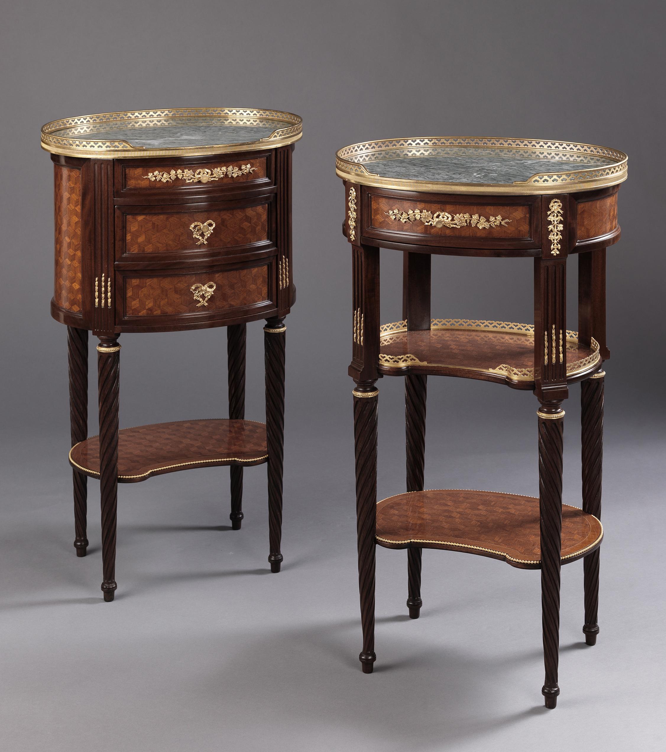 A fine companion pair of Louis XVI style gilt-bronze mounted Mahogany and cube parquetry guéridon or bedside tables with Vert Maurin marble tops.

French, circa 1880. 

Each guéridon is of oval shape with a pierced gilt-bronze gallery and a Vert