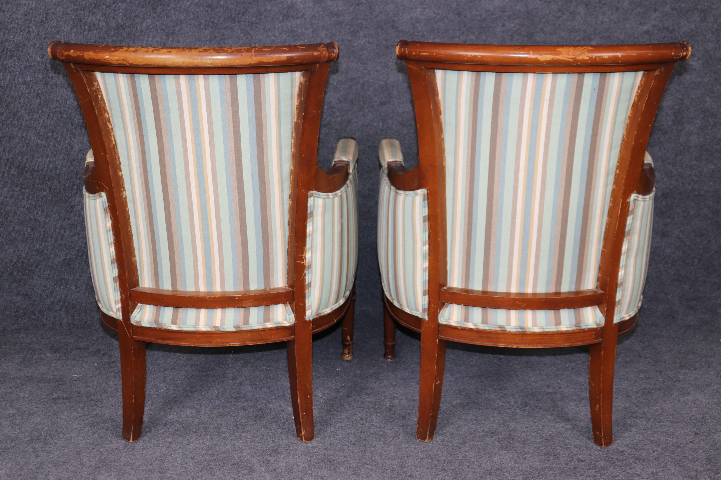 20th Century Pair of Louis XVI Style Distressed Carved Wood Bergere Chairs With Upholstery For Sale