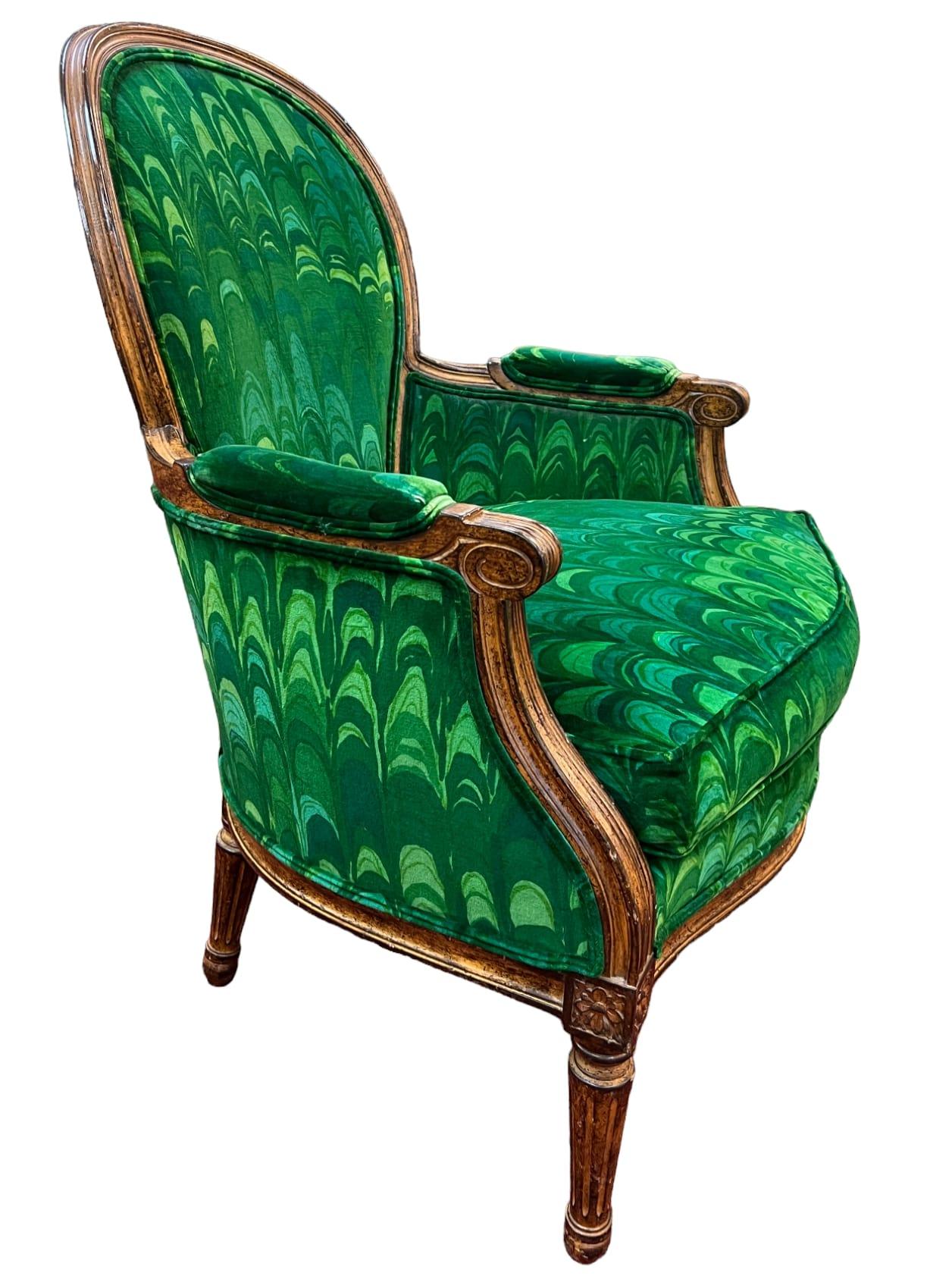 A pair of Louis XVI-style Fauteuil armchairs crafted by Lewis Mittman Inc. These armchairs are upholstered in a contrasting vibrant green velvet fabric in a peacock pattern. The peacock pattern adds a unique visual element to the chairs. The double