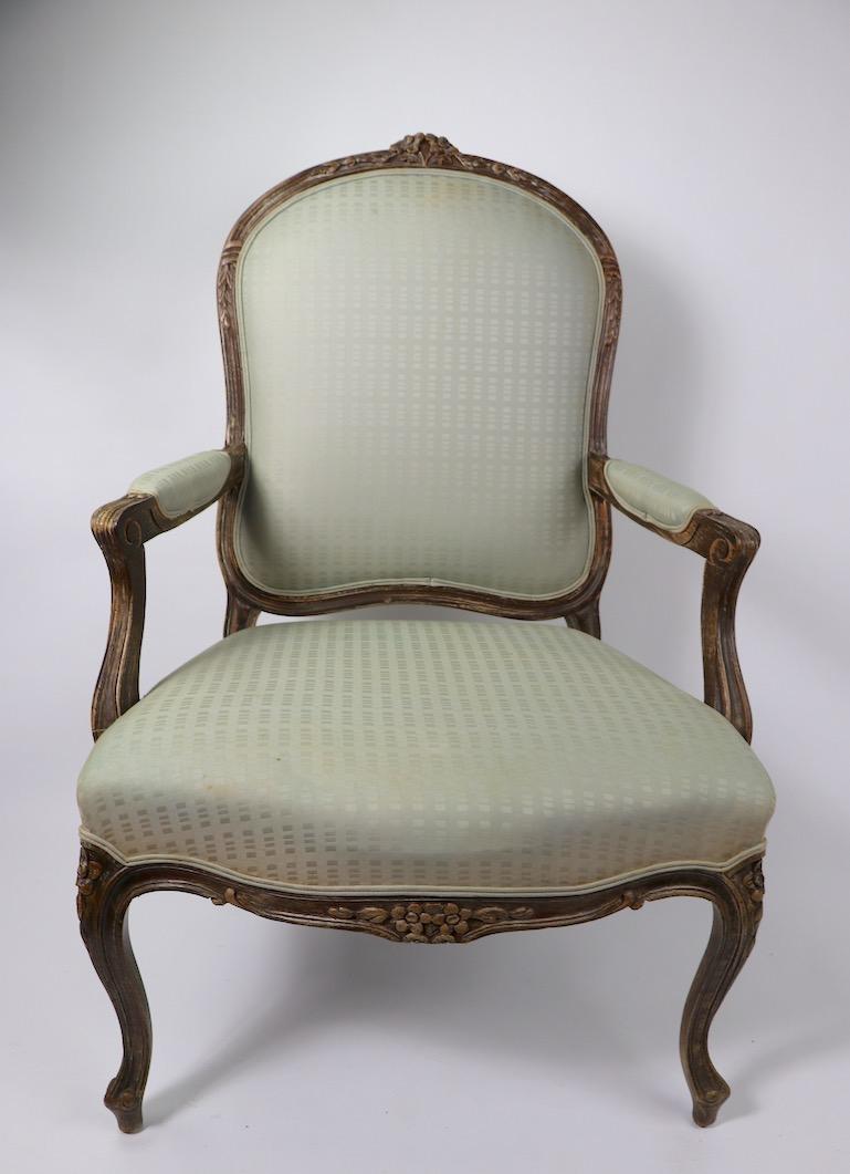 Pair of Louis XVI style fauteuils armchairs, both are structurally sound and sturdy, both will need to be reupholstered. 20th century examples - offered and priced individually, but we would love to see them stay together. Measures: Seat H 17 inches