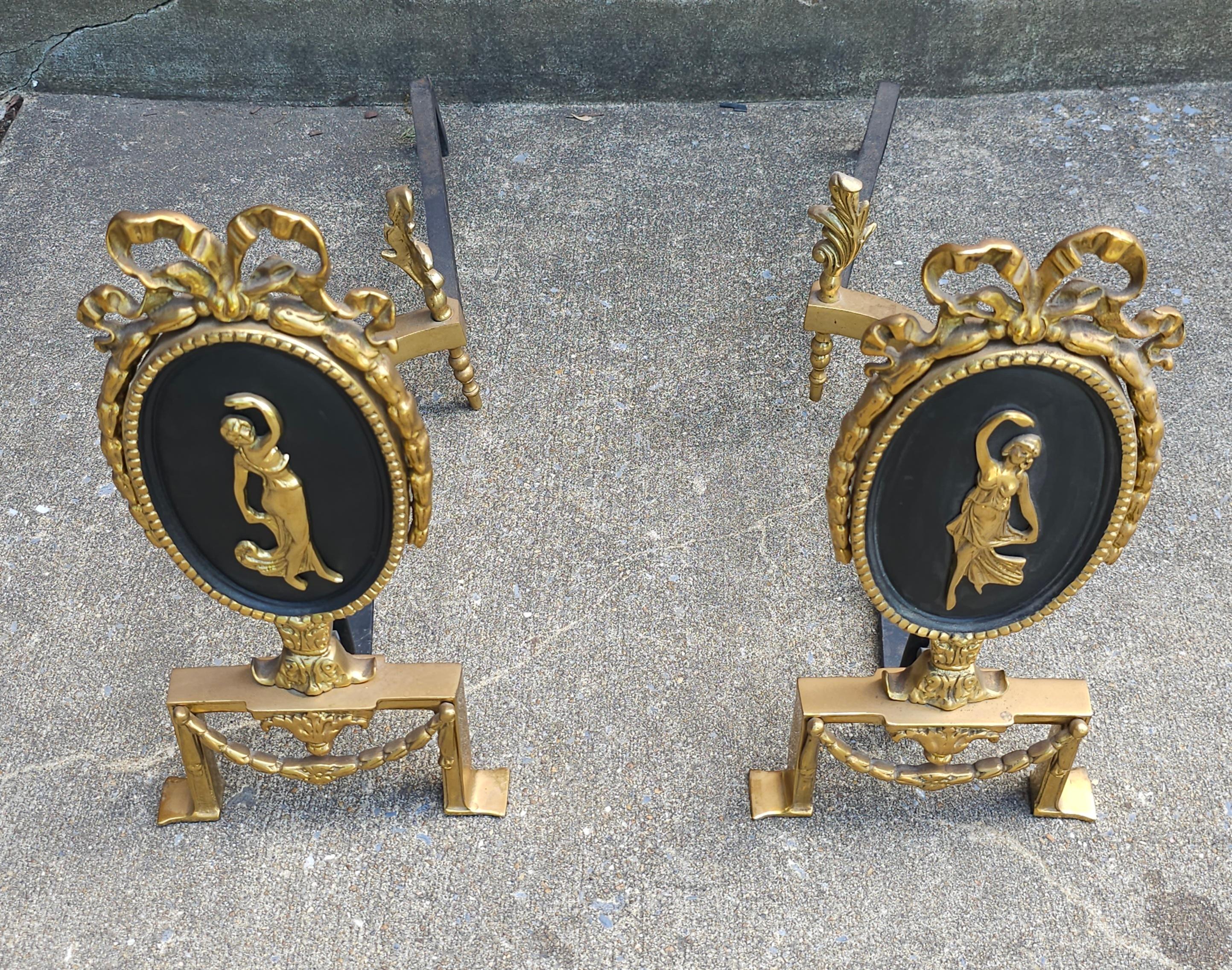 Pair of Louis XVI Style Figural Brass and Iron parcel Ebonized and Ribbon Decorated  Andirons
Measures 7.5
