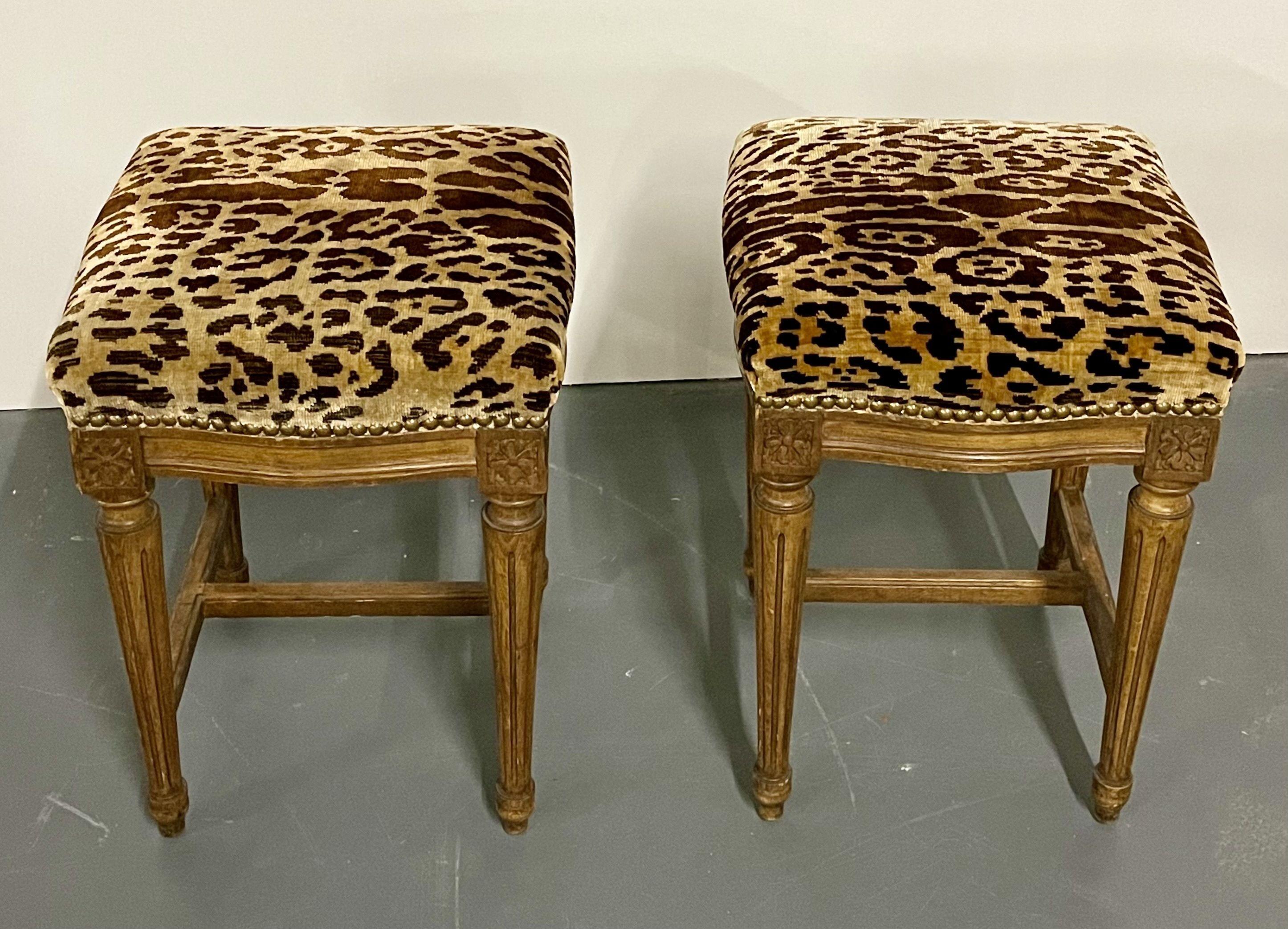 Pair of Louis XVI style foot stools, benches or ottomans, each in a faux leopard recent upholstery. The pair supported by tapering reeded legs with a lower stretcher.

Several photographs shot directly from Dr. Shawn Garber's home on the Gold