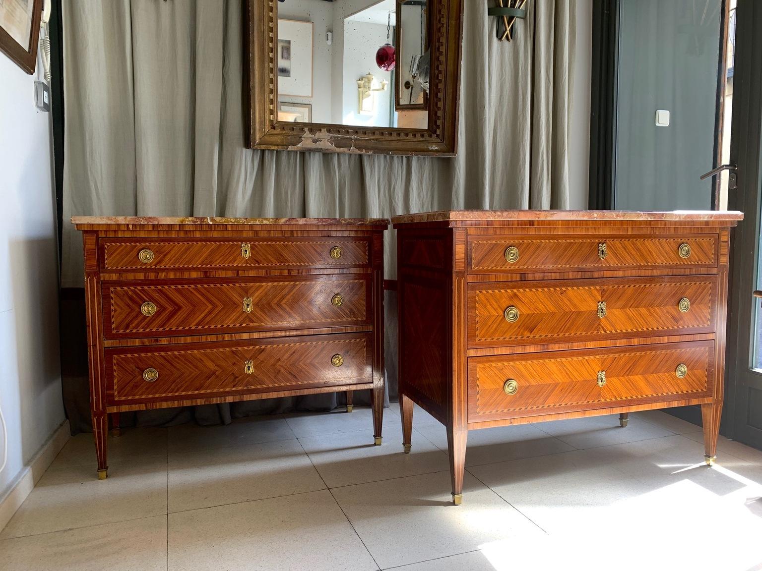 An elegant pair of French commodes, in Louis XVI style, made of fruitwood mahogany and marquetry work. the interior is valmunt,
Each of the dressers have three drawers with gilt bronze handles and keyholes.
The tops are made of marble, one slightly