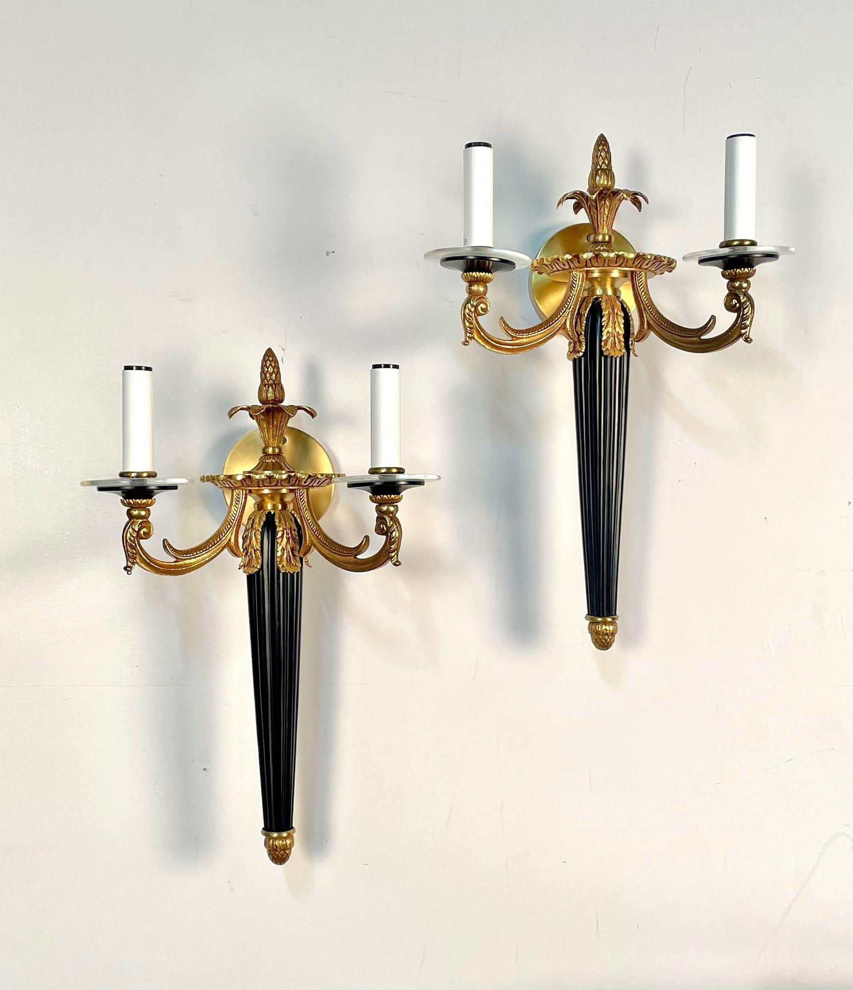 Pair of Louis XVI Style French Sconces, Ebony and Bronze, Two Light, Electrified in the Manner of Maison Bagues

A strickingly well crafted pair of stylish wall sconces each having bronze adornments with a reeded ebony column center. The pair having