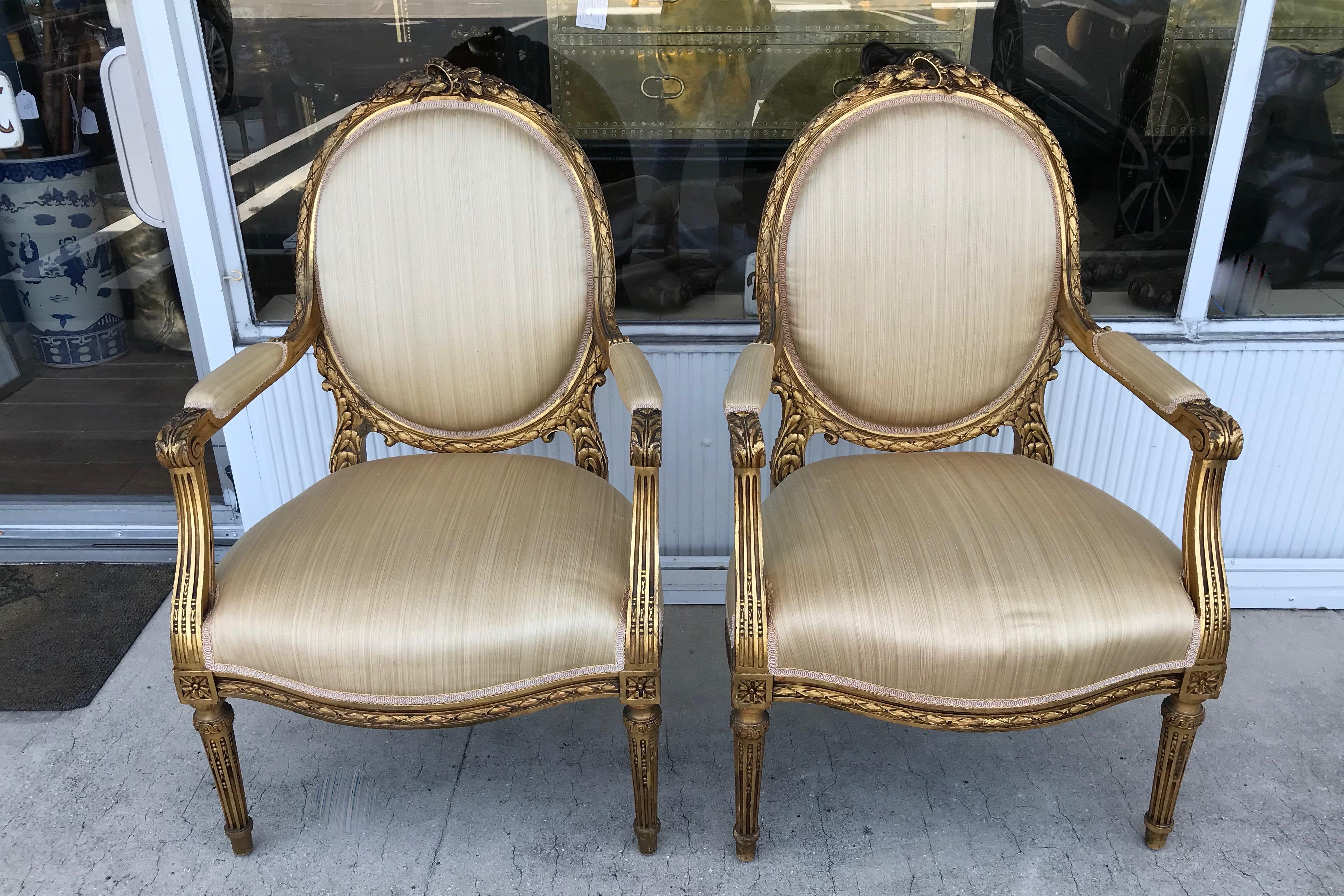 A stunning pair with fine acanthus leaf carving.
The chairs are raised upon reeded legs and are upholstered 
with silk. Superior quality - beautiful scale. A superb pair.