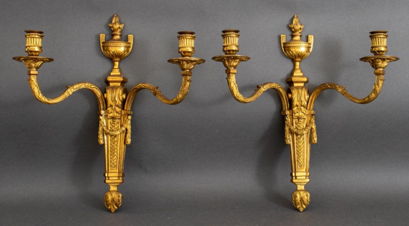 Pair of Louis XVI style gilded two light wall sconces, each with urns en flambeau above acanthus cast and garland hung supports.

Dealer: S138XX