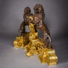 Pair of Louis XVI Style Gilt and Patinated Bronze Chenets with Lions Rampant