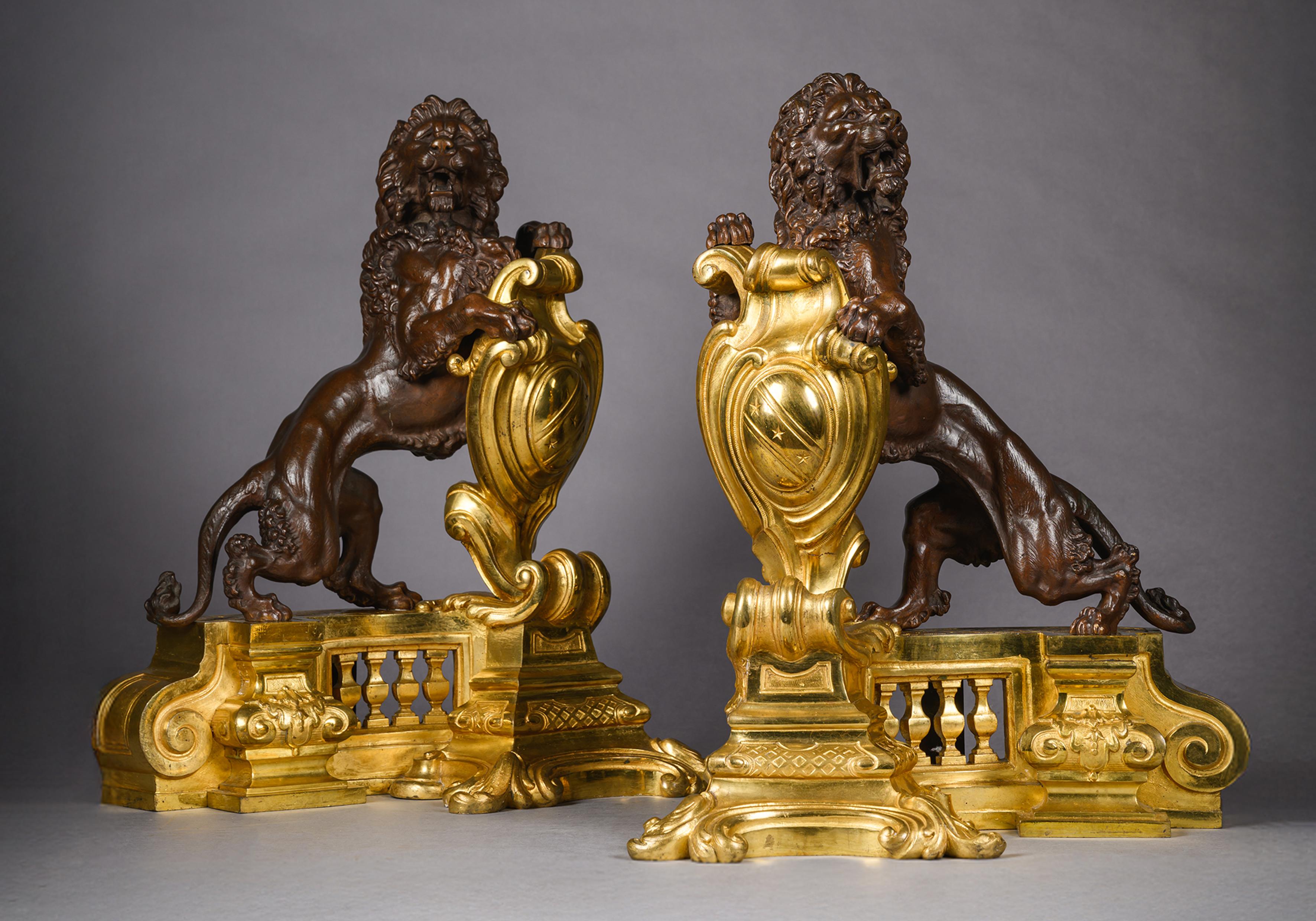 Pair of Louis XVI Style Gilt and Patinated Bronze Chenets with Lions Rampant For Sale
