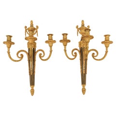 Pair of Louis XVI Style Gilt and Patinated Bronze Three Light Sconces