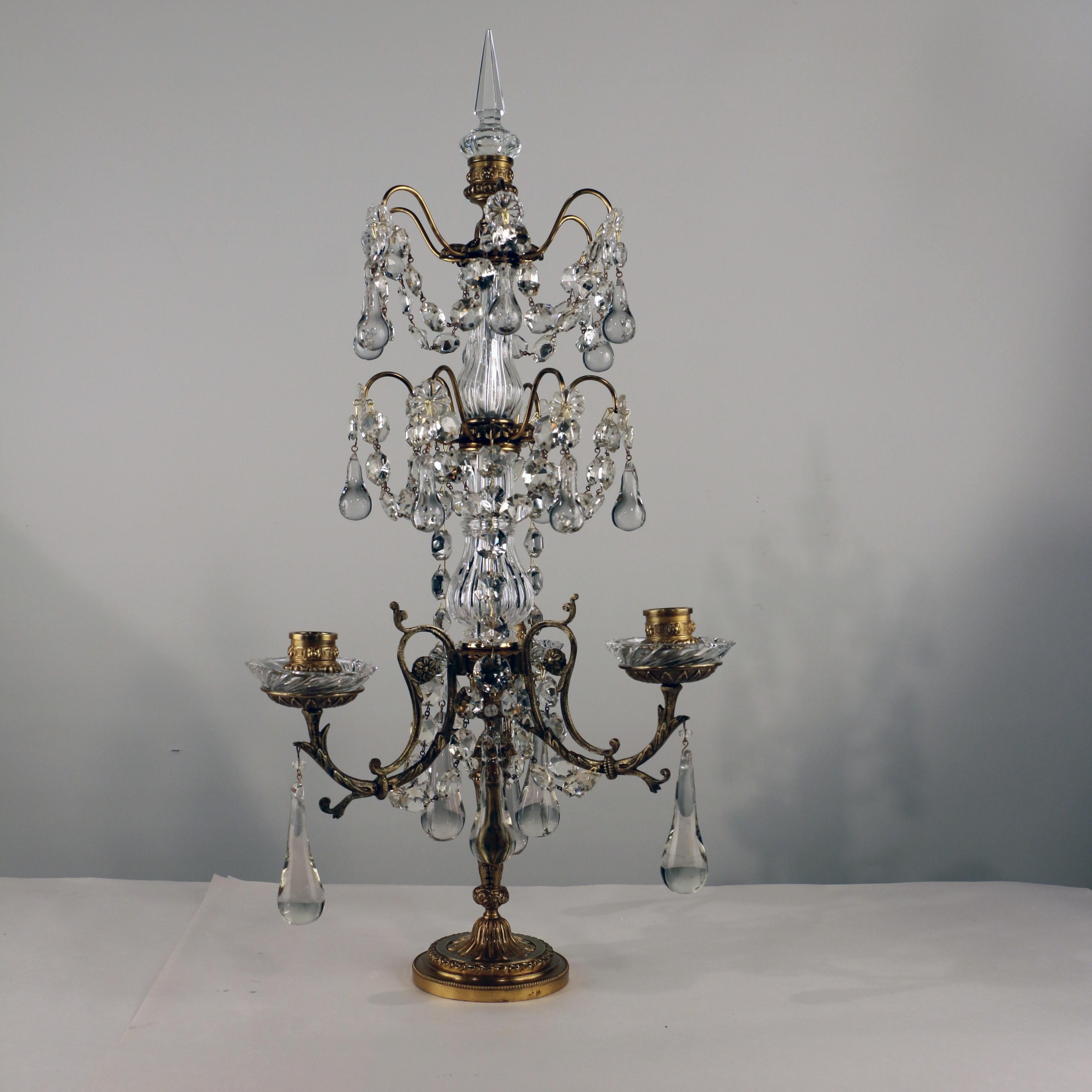 These have a delicacy and lightness that is a welcome departure from the hefty look girandoles often have. The bronze is cast in slender branches and the tiers of lead crystal drops, swags, and rosettes are mounted on rather slender elements too.