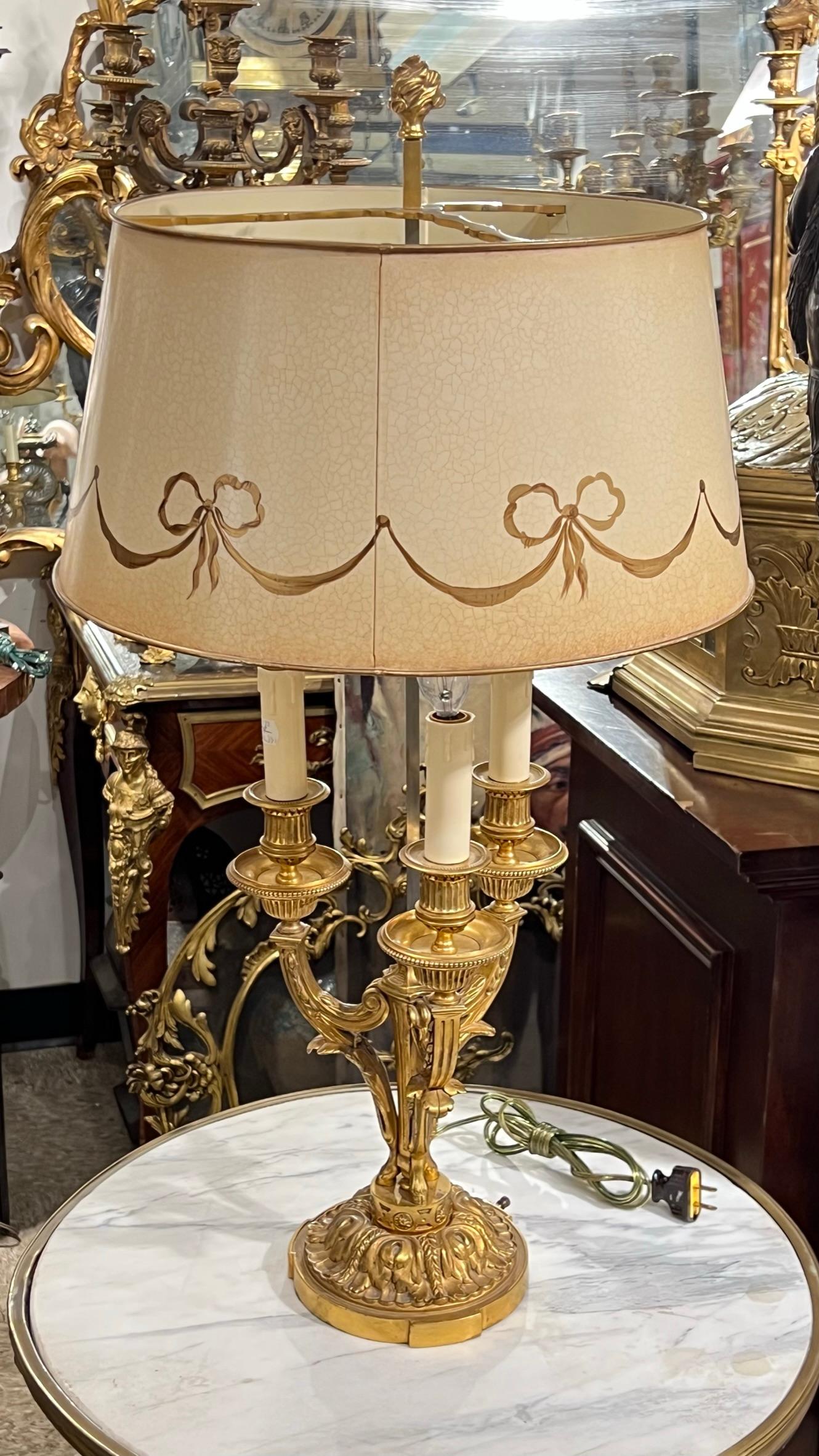 Pair of French 19 century  gilt bronze French bouillotte Lamps with hand-painted metal shades, with wiring and sockets, ready for use.
The Candelabras are 19 century and converted to electrical lamps in the 20th century with hand painted tole shades.