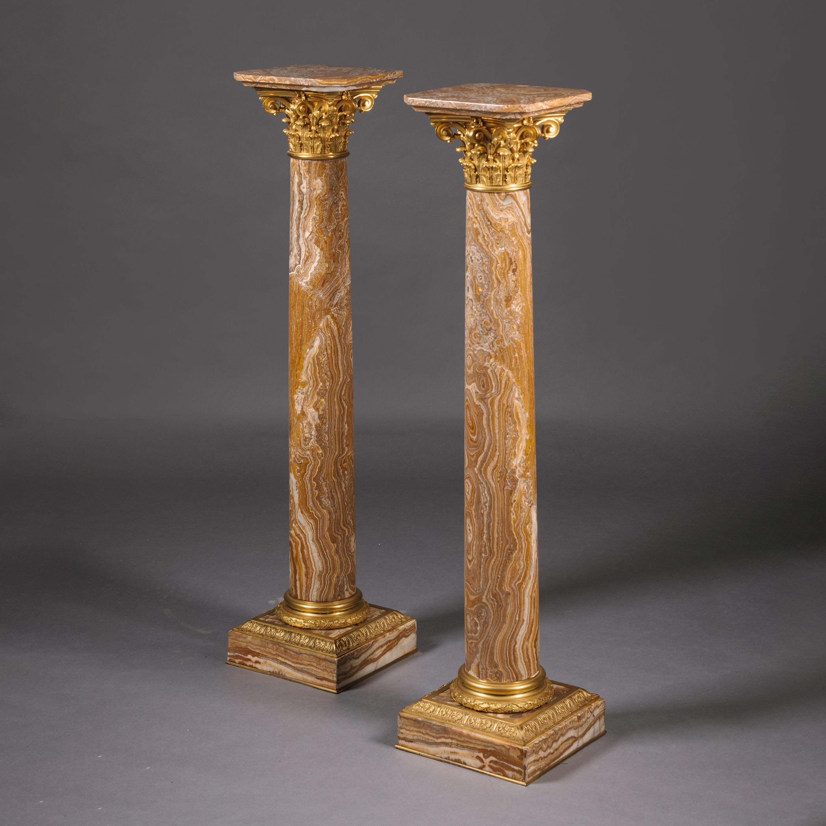 A Pair of Louis XVI Style Gilt-Bronze Mounted Alabastro Fiorito Antico Pedestal Columns. 

The pedestals are of classical form with finely figured Alabastro Foiorito columns and gilt-bronze Corinthian capitals and laurel leaf plinth bases.  Each