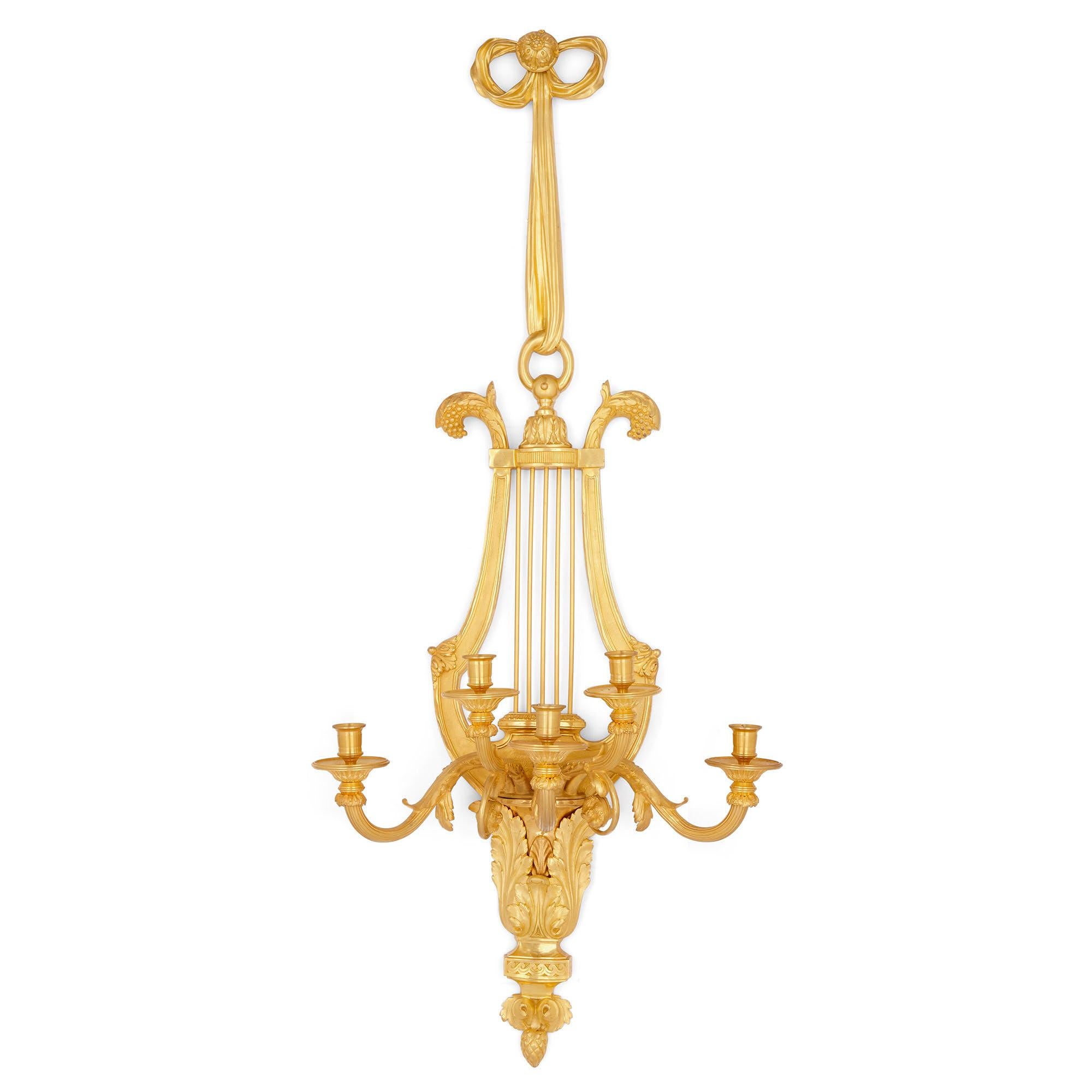 Pair of Louis XVI style gilt bronze sconces
French, circa 1900
Measures: Height 134cm, width 57cm, depth 34cm

This beautiful pair of sconces-or wall lights-is wrought from superbly formed gilt bronze. Each sconce in the pair is designed about