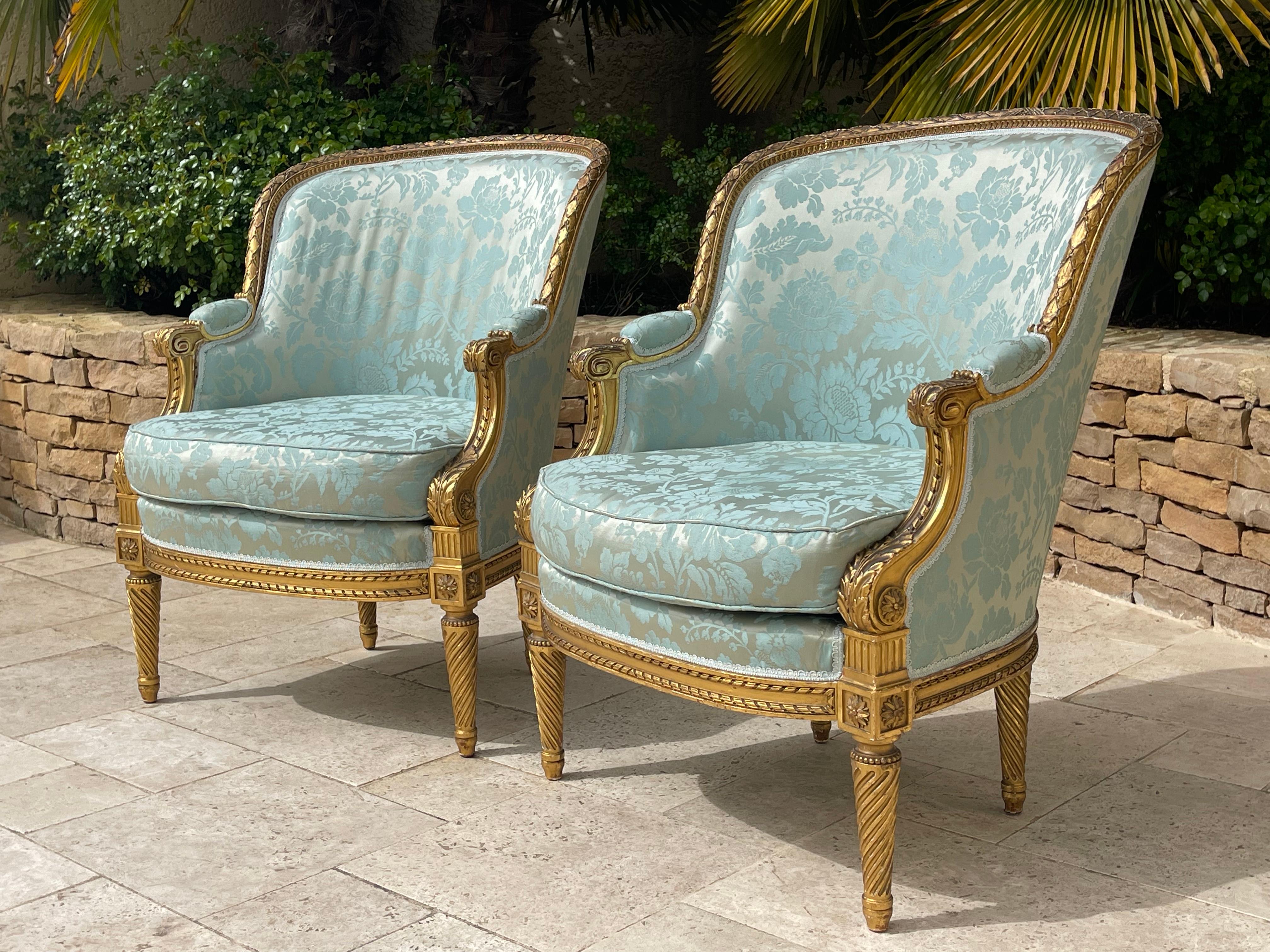 Pair of Louis XVI style gilded wood armchairs covered with floral patterned fabric. 'The size is very important and imposing. They are very decorative, the structure is entirely original and the gilding is with gold leaf. Solid and very stable,