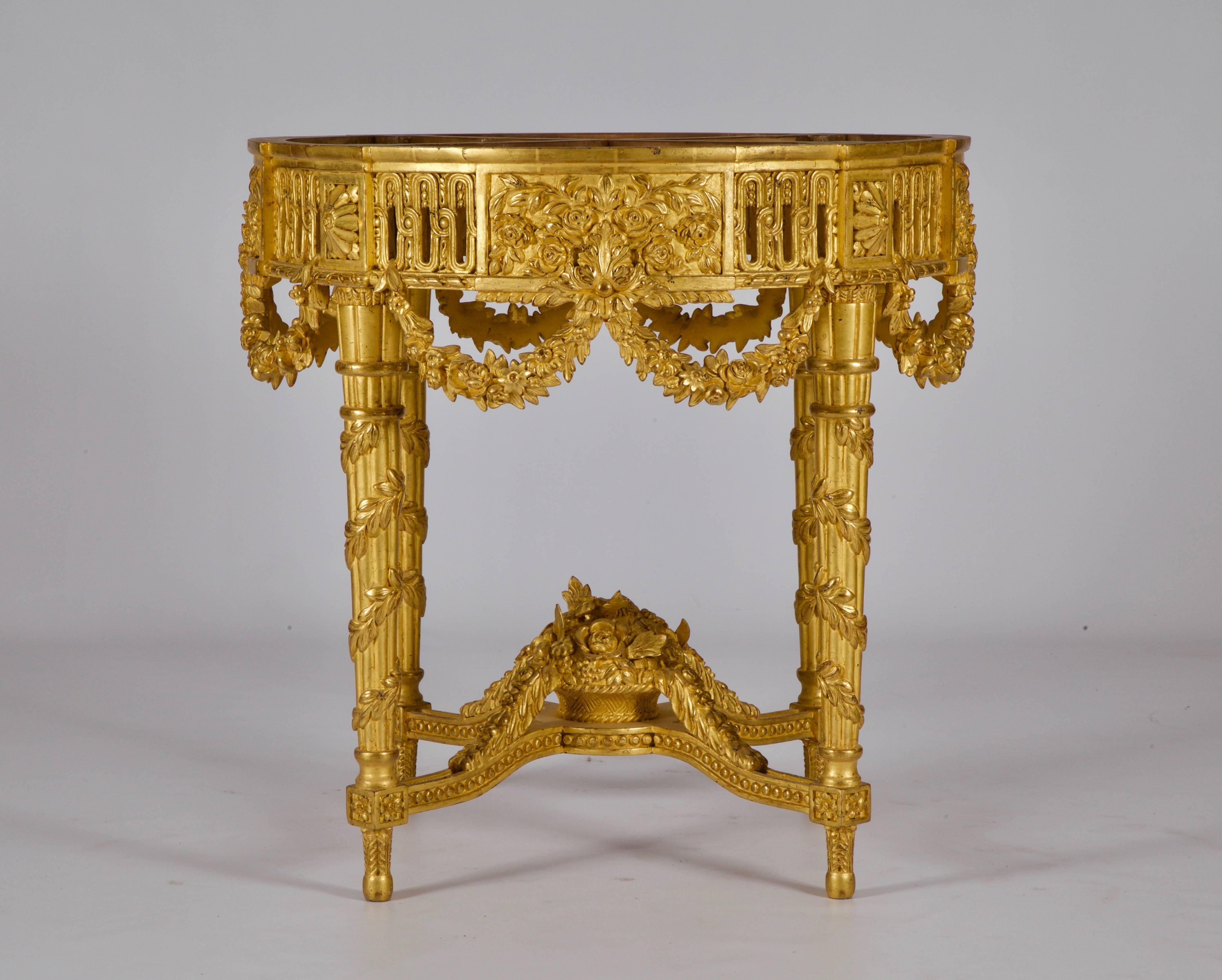 Pair of Louis XVI style round Side tables: Hand-carved by master craftsmen and hand finished in a medium, aged and distressed, water gilded patina made using 23.75 carat gold leaf.
Beveled tops can be made to order, from our marble selections, on