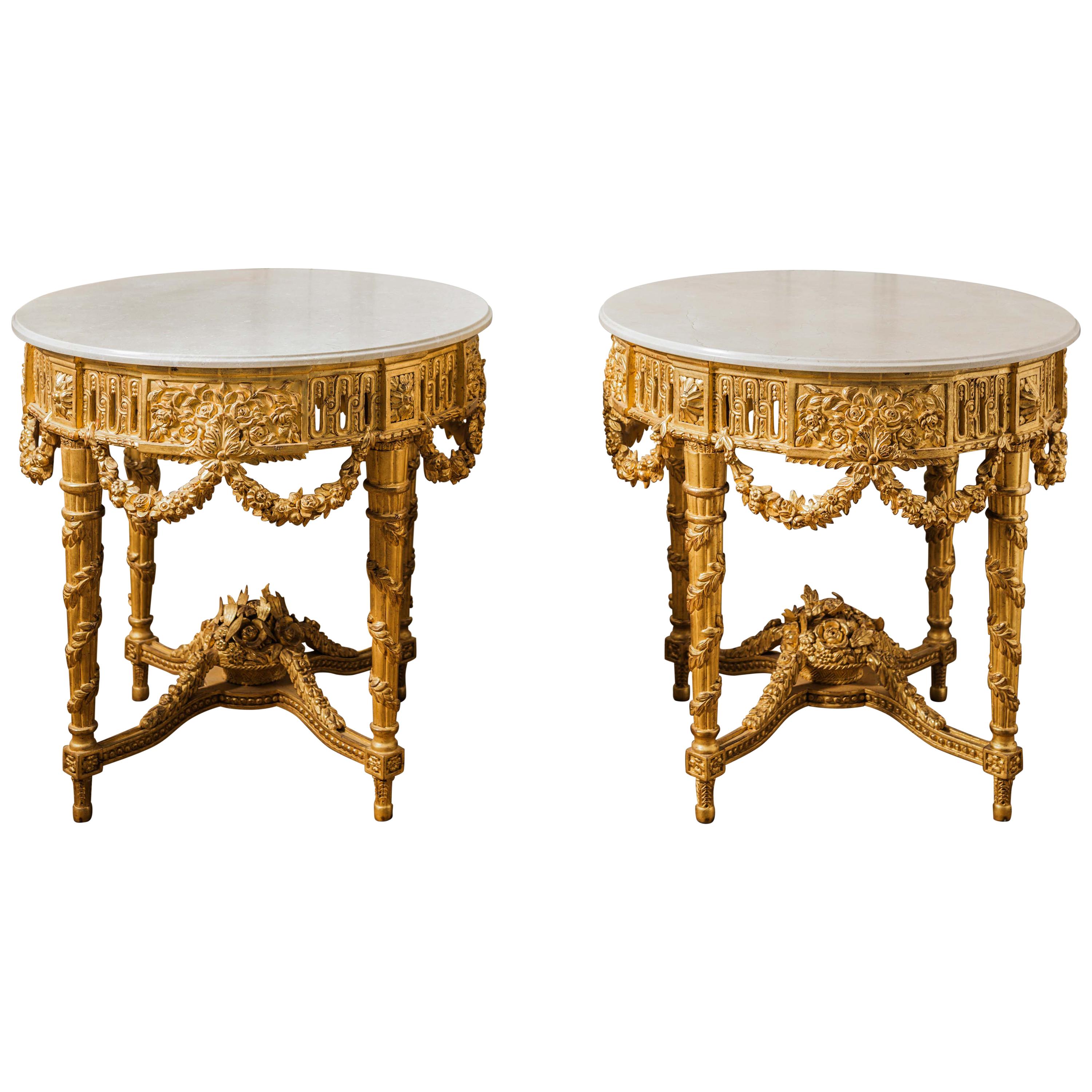 Louis XVI style, side tables. Finely hand-carved by master craftsmen and finished in a water gilded patina using 23.75 carat gold leaf, lightly aged and distressed.
Includes the beveled creme marfil marble tops, honed, sealed and waxed.
Price quoted