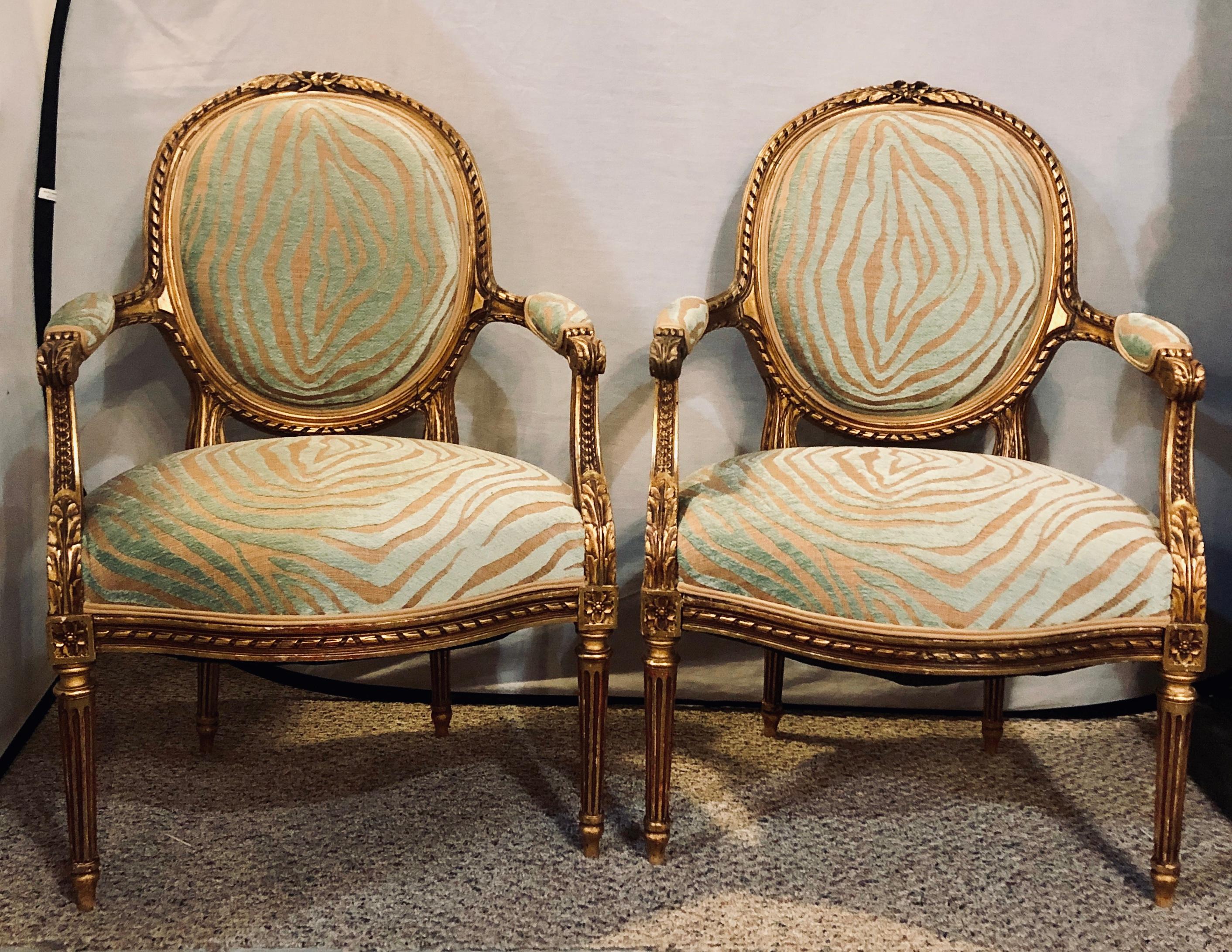Pair of Louis XVI style green zebra striped fauteuils or armchairs in a wonderful gilt gold distressed finish.