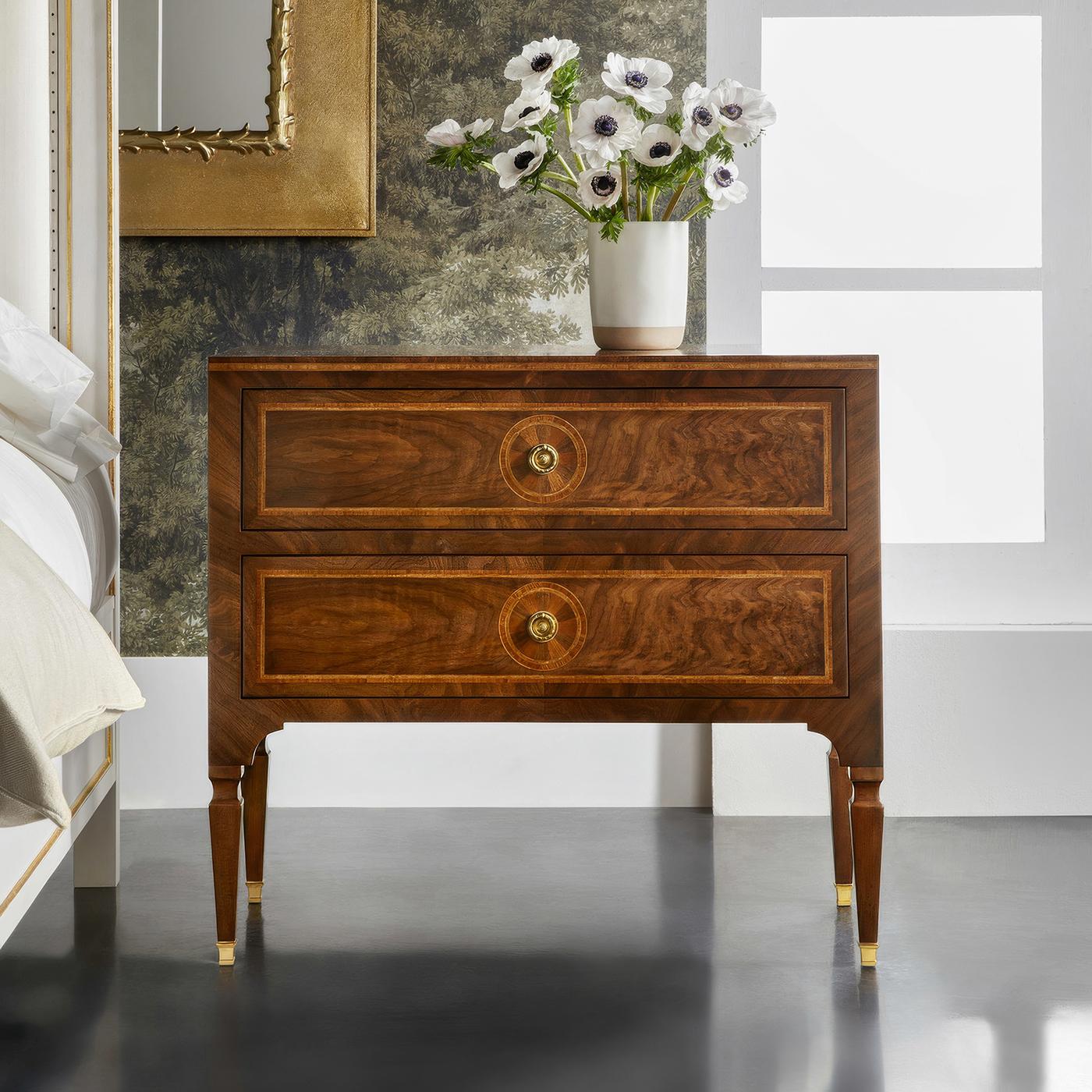 Expertly crafted from Burl Walnut, Walnut, and Prima Vera veneers, this piece showcases exquisite inlays in a geometric design that embodies classic French sophistication. The two spacious oak drawers are equipped with modern soft-close mechanisms