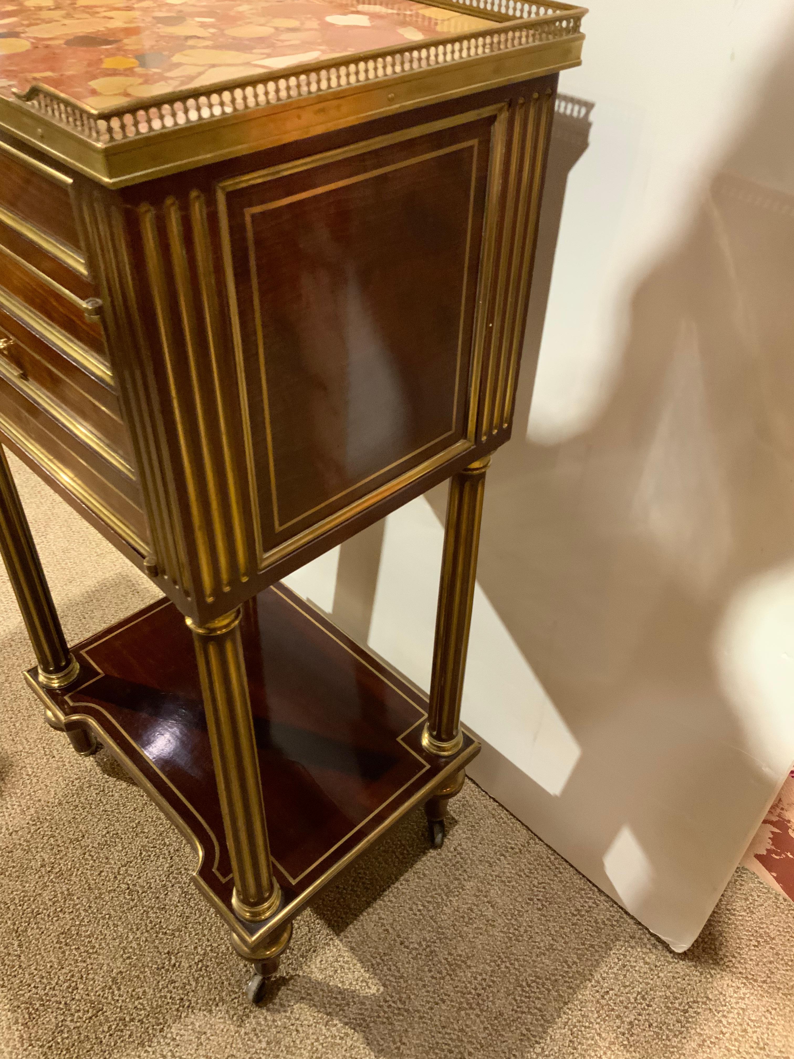 This is a fine pair of cabinets that are made of a warm mahogany 
With the original finish. The marble is in great condition without
Breaks or chips. They have one drawer over a door that opens
To an interior lined with marble. The top has a