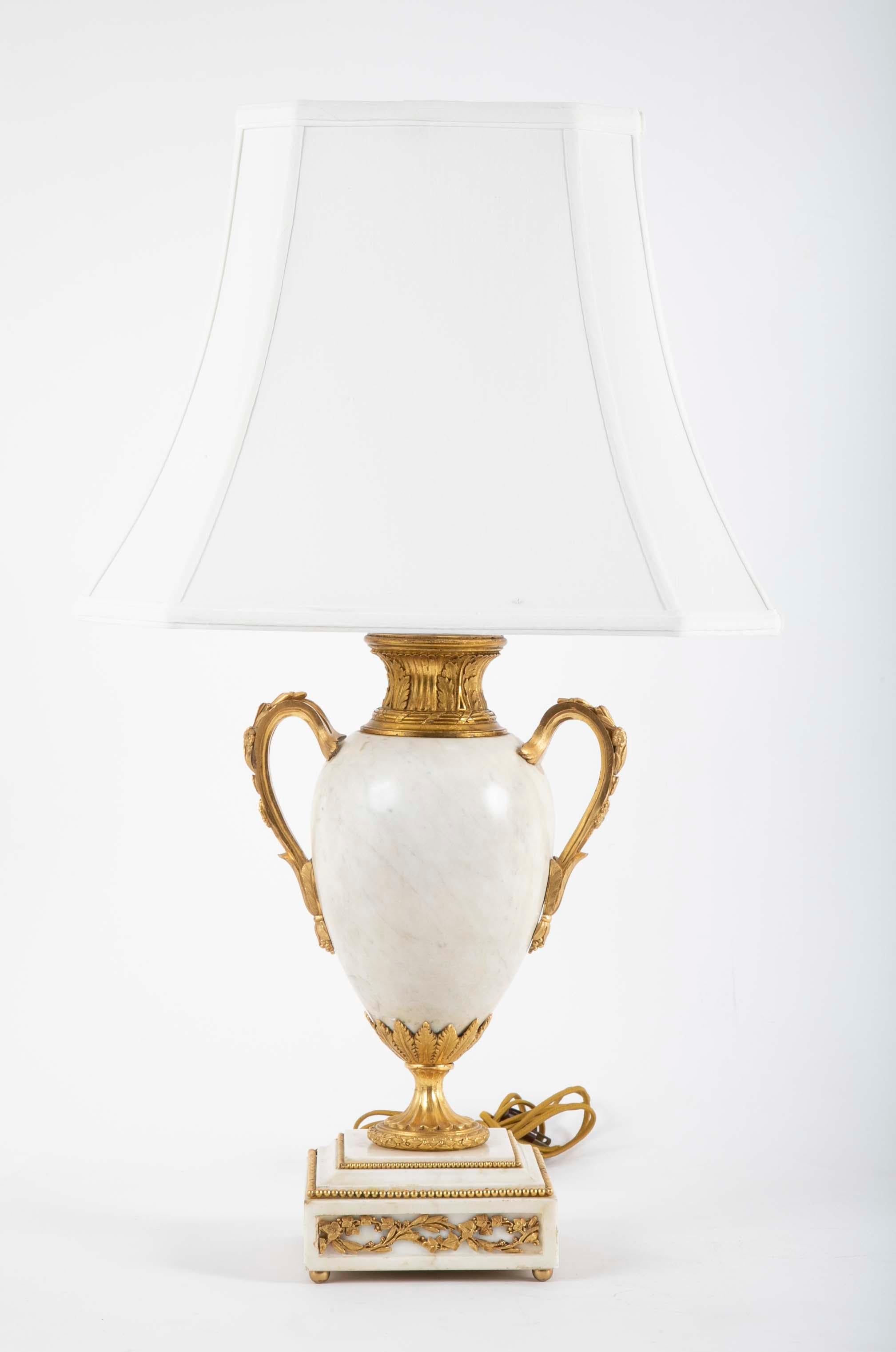 Pair of Louis XVI style ormolu mounted lamps with baluster form white marble vases on square marble base.. 

Provenance: Christie's, New York, 2003.