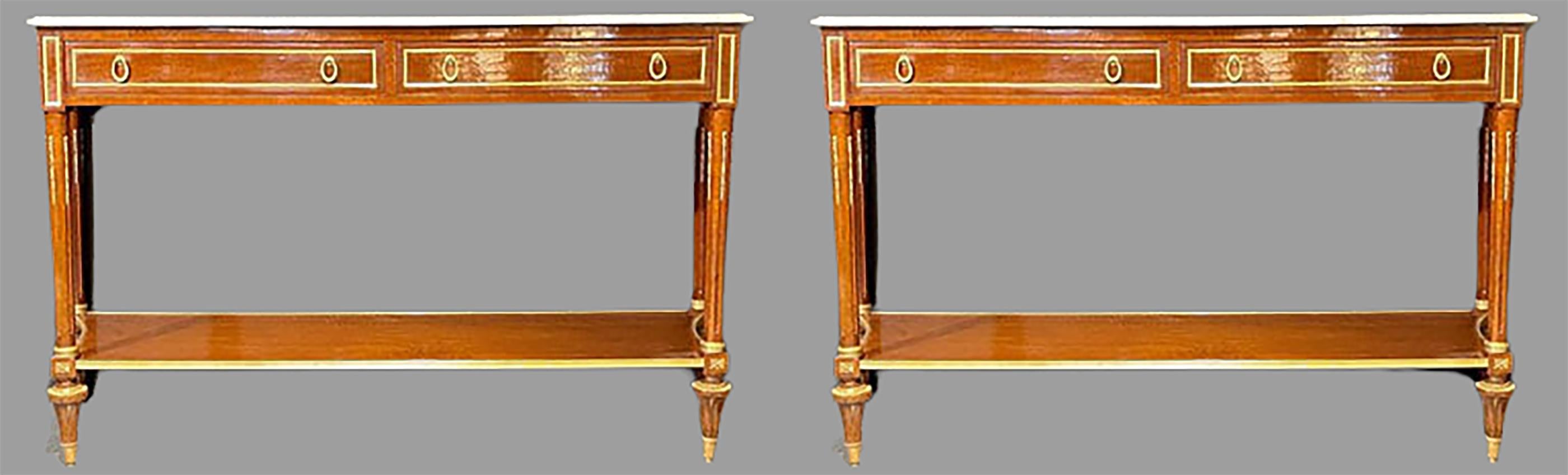A fine pair of Louis XVI style marble top consoles or sideboards in the Maison Jansen Manner. These simply stunning concave sided consoles have tortoiseshell veneers that have been wonderfully refinished. The bronze framed drawers supporting a white