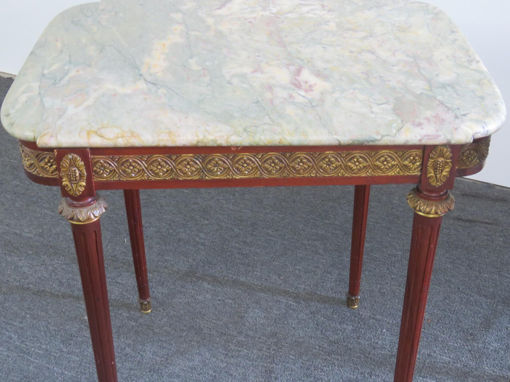 Pair of Louis XVI style marble-top end tables, in the manner of Forest, with bronze mounts and sabots.