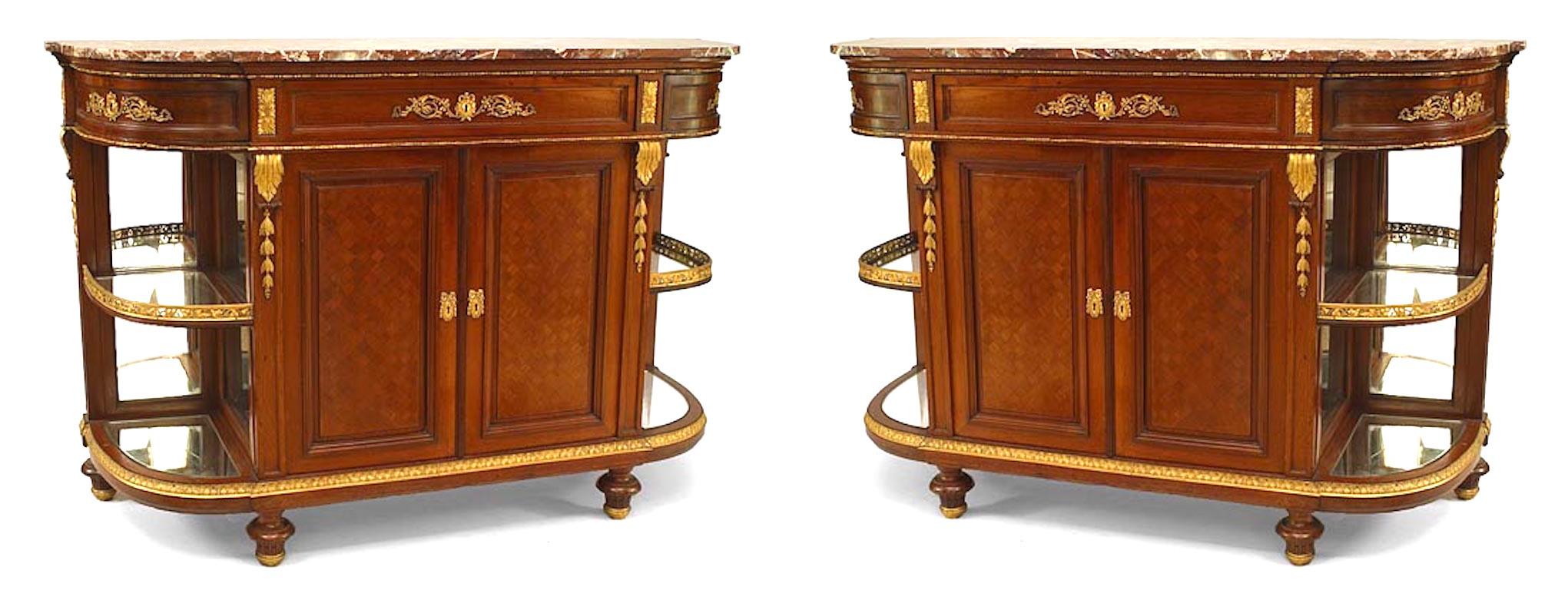 Pair of French Louis XVI Style bronze trimmed mahogany sideboards with curved mirrored side shelves and marble tops.