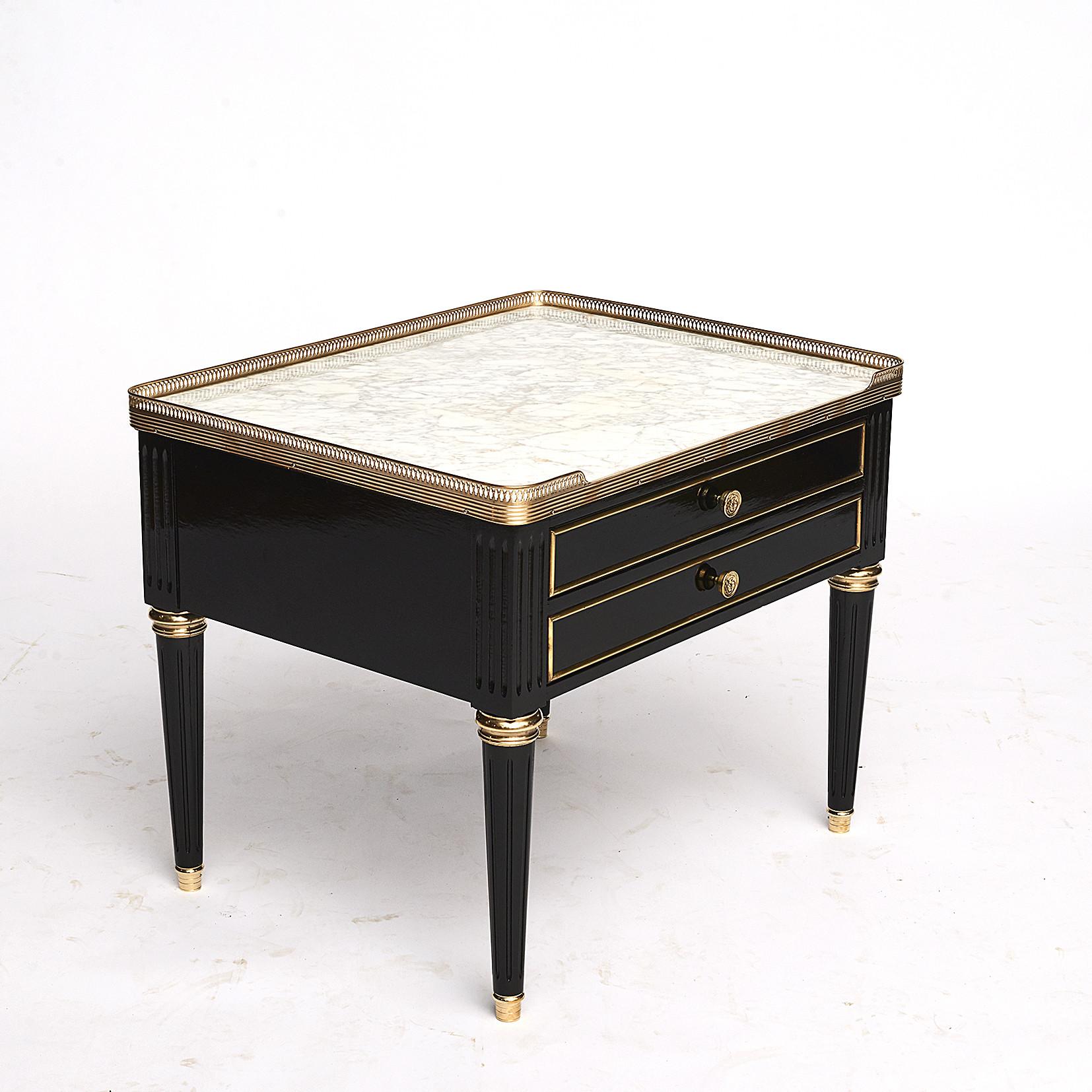 Pair of French Louis XVI style side tables or nightstands in ebonized mahogany with beautiful Carrara marble tops and pierced brass gallery rails. Two drawers with brass trim and knobs, elegant tapered legs.
France, circa 1970.