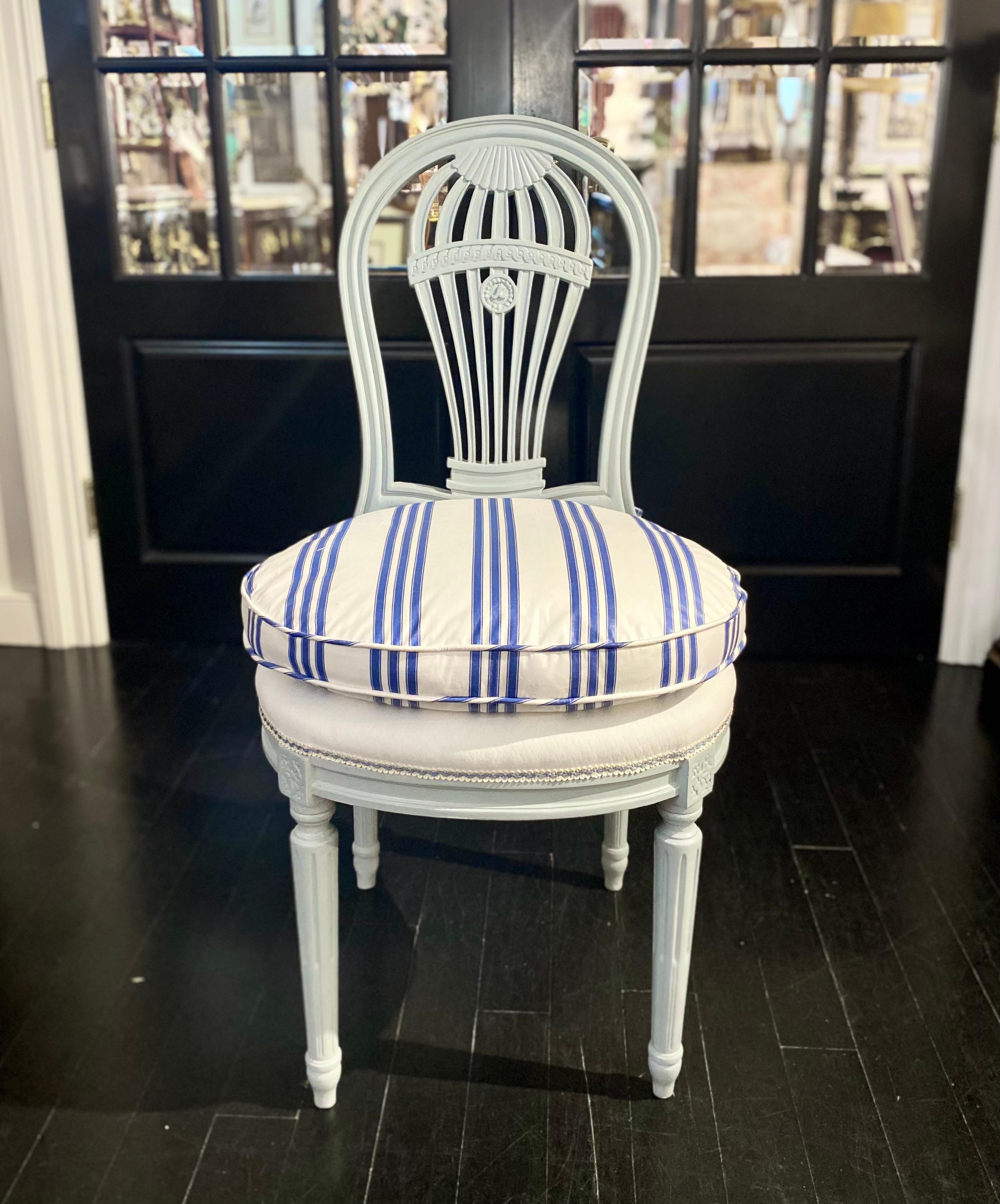 Set of 2 Louis XVI style French chairs from the mid 20th century.

Newly painted wood in pale blue and upholstered in blue-stripped fabric, beautiful model. Tapered legs. Hot-air balloon pierce-carved pattern on the backrests.

Brand new