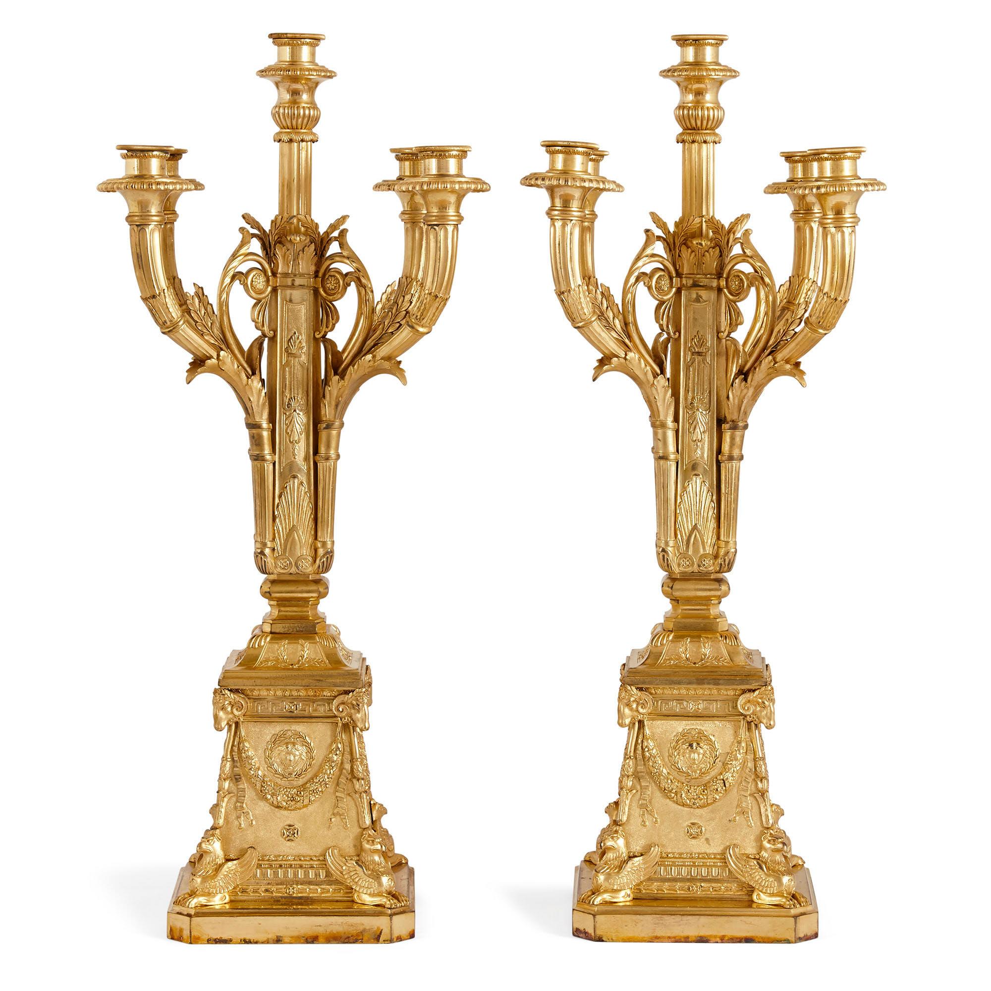 Pair of neoclassical style gilt bronze candelabra by Susse Frères
French, circa 1900
Measures: Height 62cm, width 24cm, depth 24cm

Each candelabrum in this pair is designed in the Louis XVI style and wrought from Fine gilt bronze. Each features