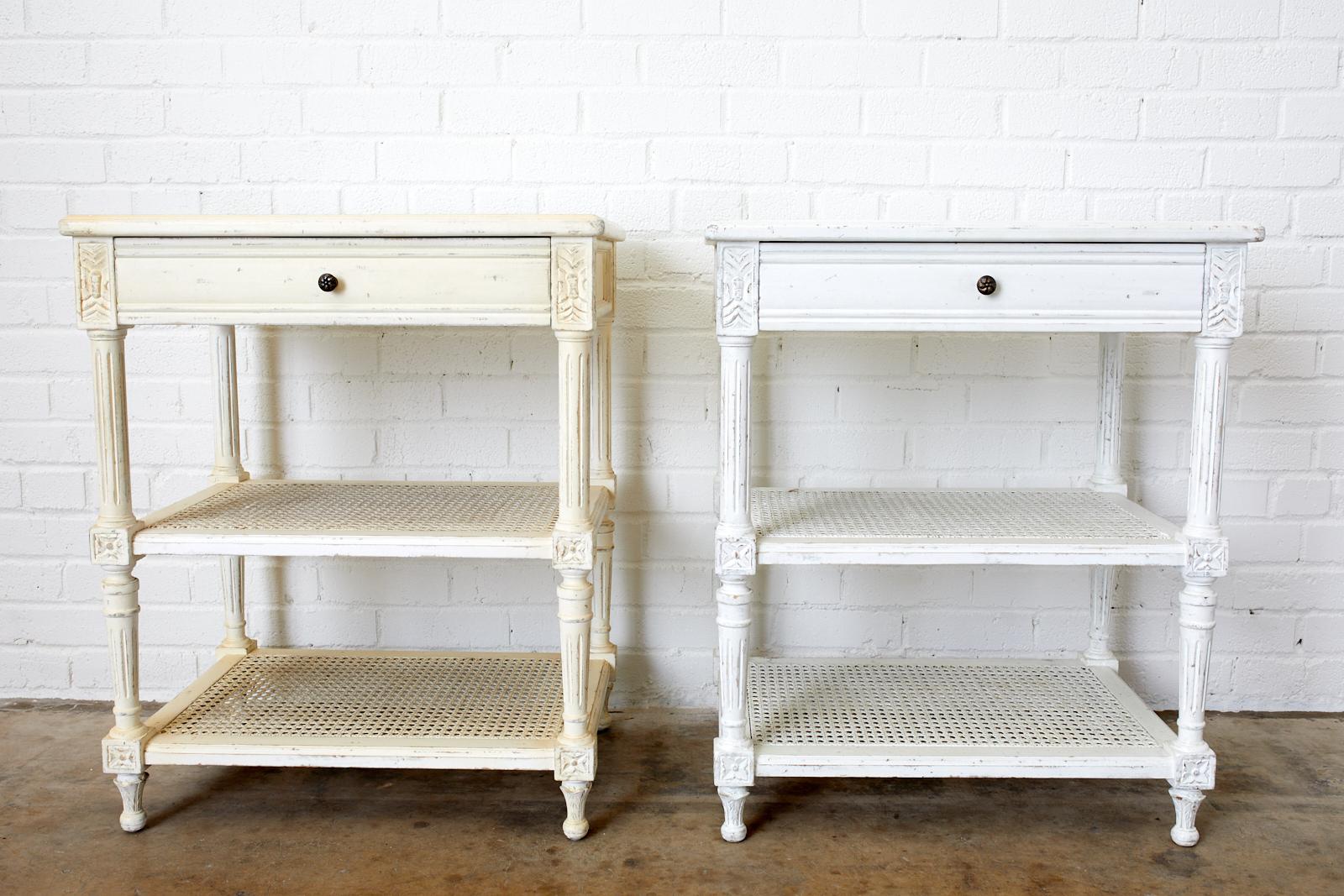 French Louis XVI style or Swedish Gustavian taste pair of painted three-tier nightstands. Featuring a white insert marble top and caned shelf design by Rachel Ashwell. Known for her country French and beach cottage style these pieces are from her