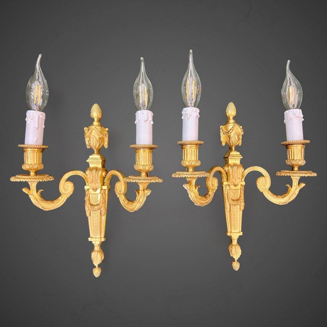 These two unique wall scones showcase well-preserved gilding with elegant ornamentation reminiscent of the Louis XVI style. The electrical wiring has been redone completely, and the fixtures are ready for installation.

