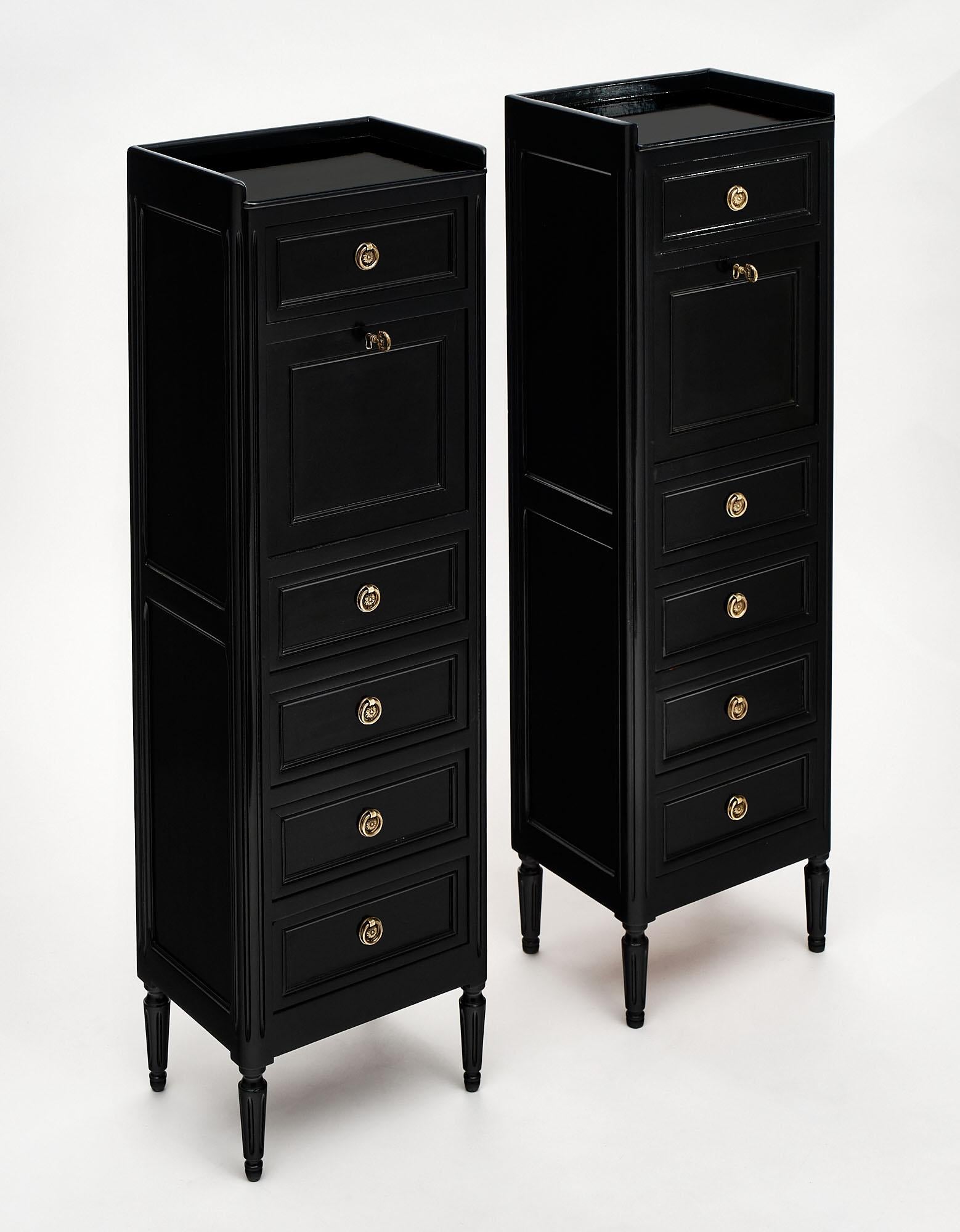 Pair of “secretaires”, French, made of cherry wood in the Louis XVI style. The pair has been ebonized and finished in a lustrous museum quality French polish. We love the drop front opening to an intimate work space with an embossed green leather