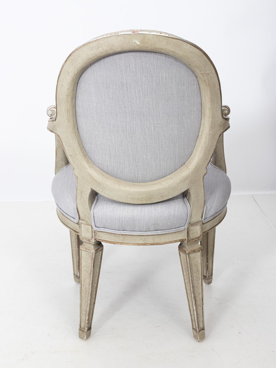 Pair of vintage Louis XVI style silver gilt painted fauteuil armchairs with oval backs, circa 1940s. Newly upholstered in soft lavender herringbone Rogers & Goffigon fabric. Please note of wear consistent with age. Made in France.