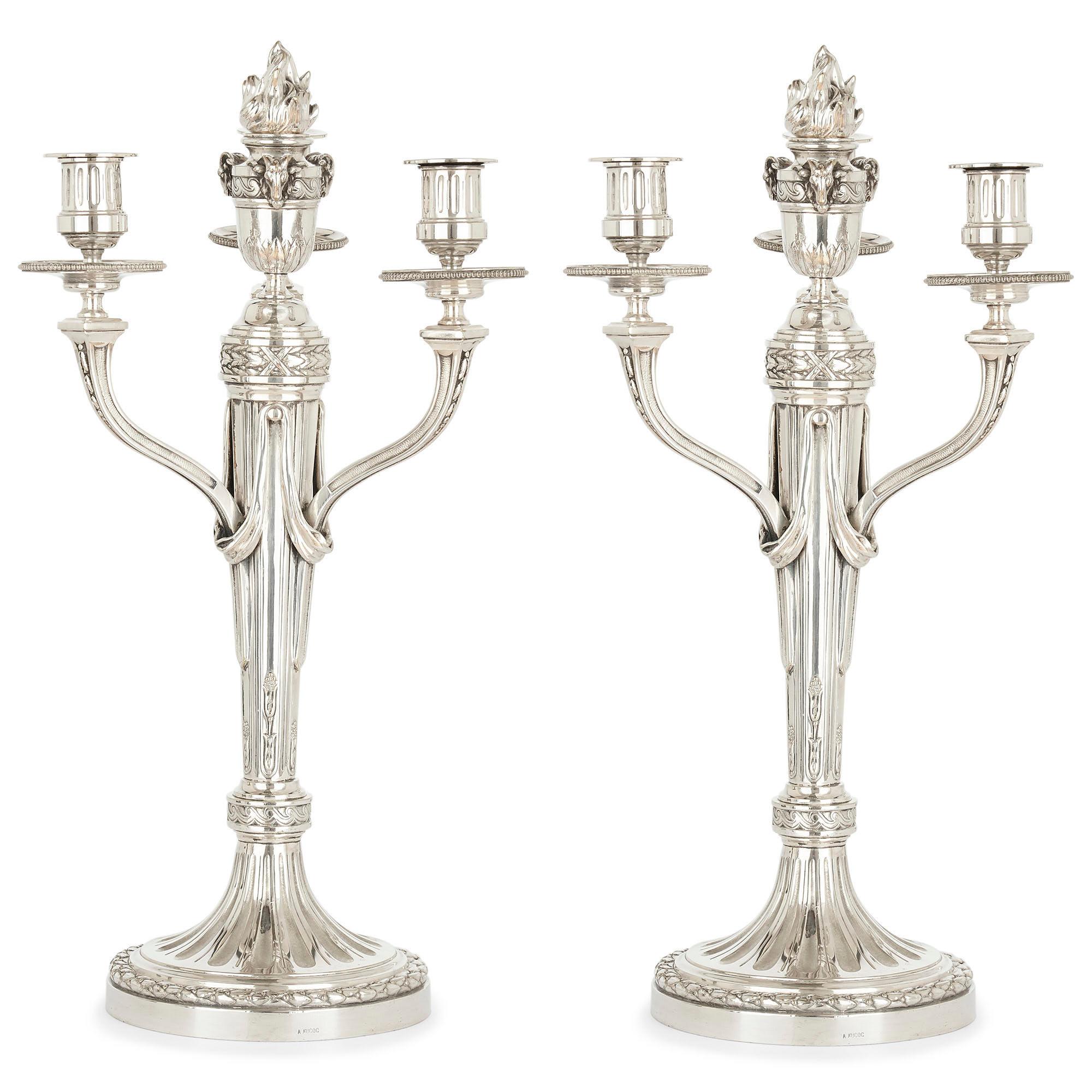 Pair of Louis XVI style silvered bronze table candelabra by André Aucoc
French, circa 1900
Size: Height 45cm, diameter 23cm

This beautiful pair of silvered bronze candelabra was made circa 1900 by André Aucoc, a leading French silversmith of