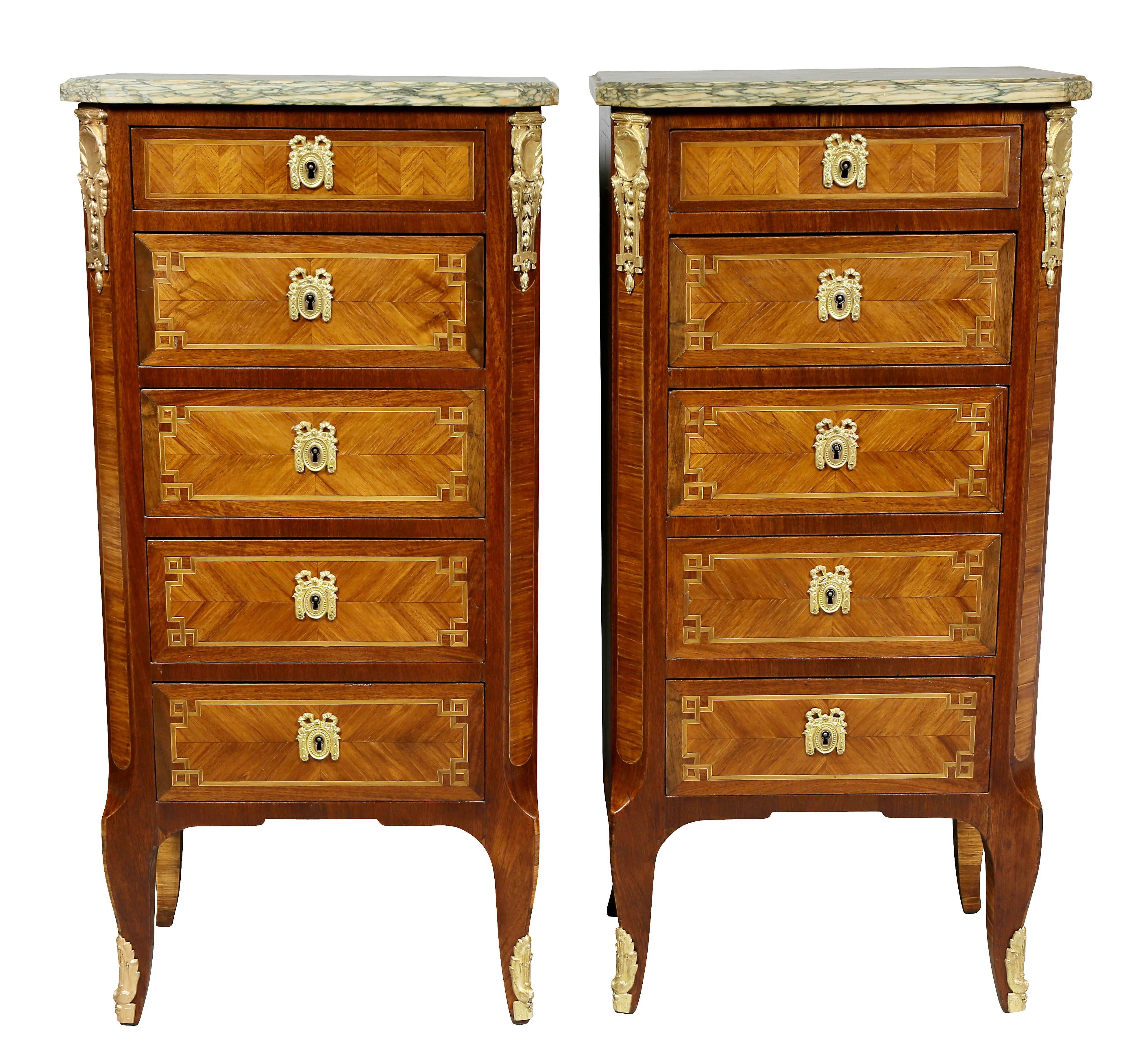 Each with green marble tops over five drawers.
