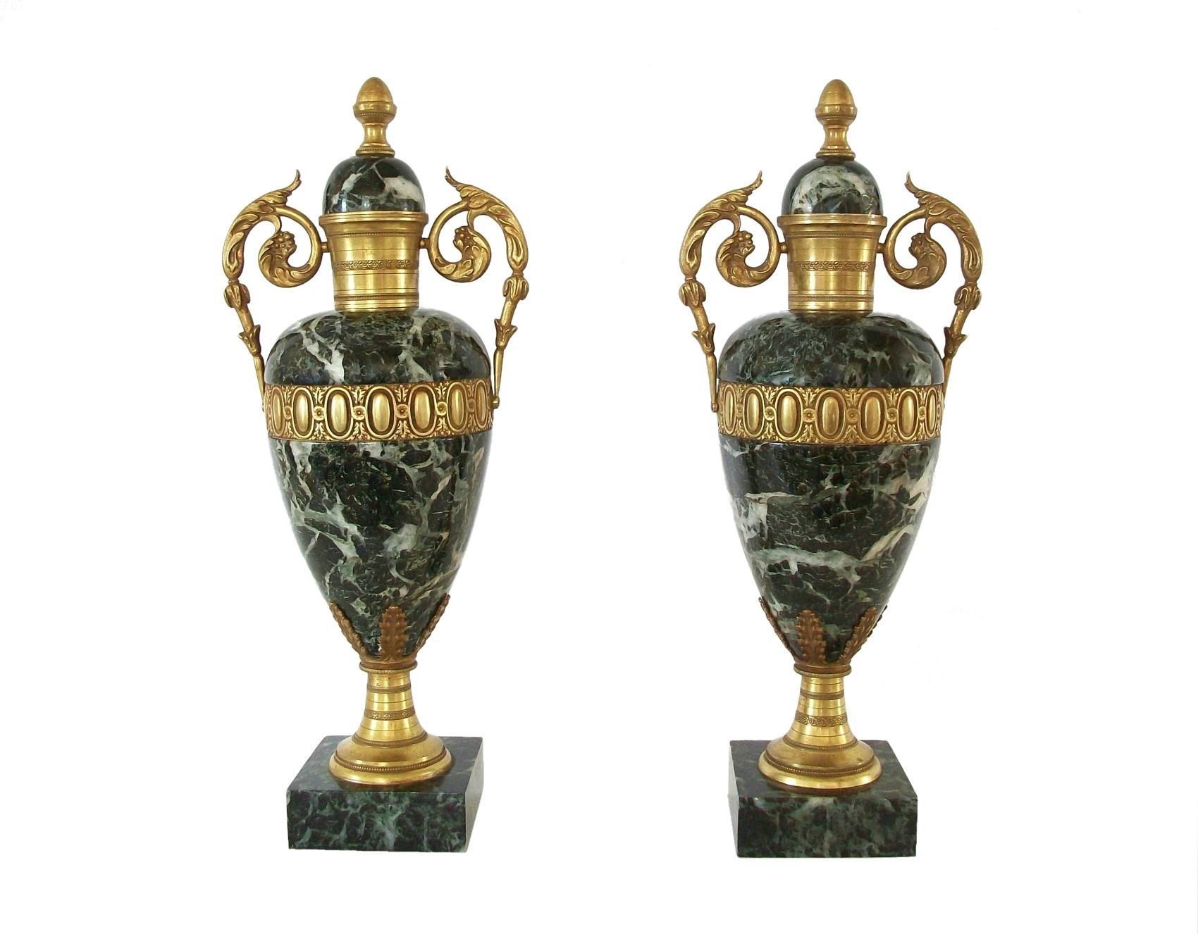 Fine pair of Louis XVI style Verde Antico Marble and gilt bronze urns - featuring fine chasing and casting to the bronze elements - lids not removable - shallow enough in depth to fit most fireplace mantels - could also be electrified as lamps -