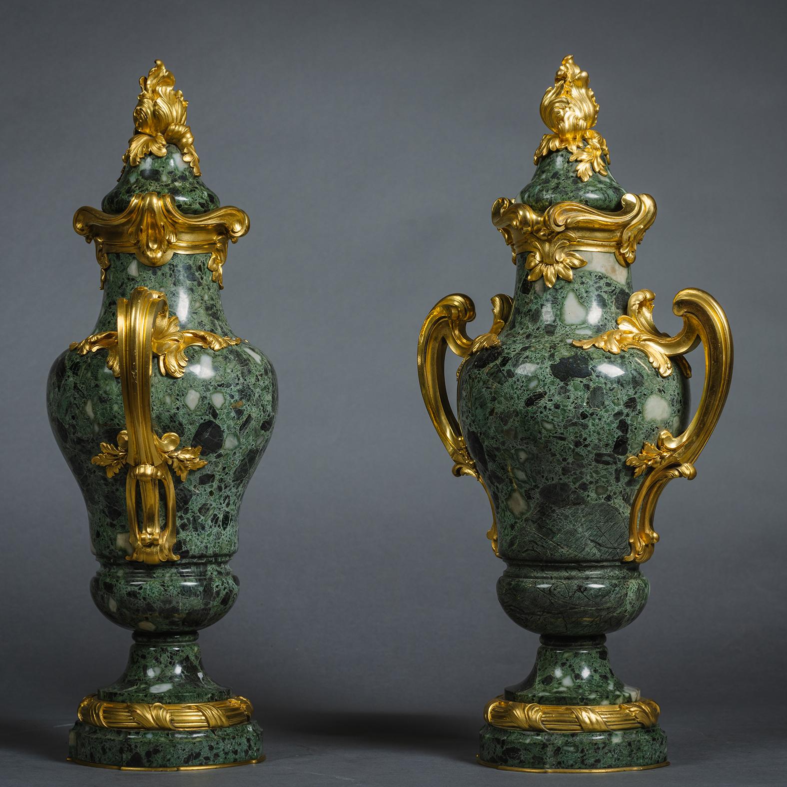 A Pair of Louis XVI Style Gilt-Bronze Mounted Verde Antico Marble Vases and Covers, by Susse Frères, After a design by F. Rambaud.  
 
Each vase is of baluster form, with acanthus finial and scrolled handles.

Each inscribed to the bronze moulding