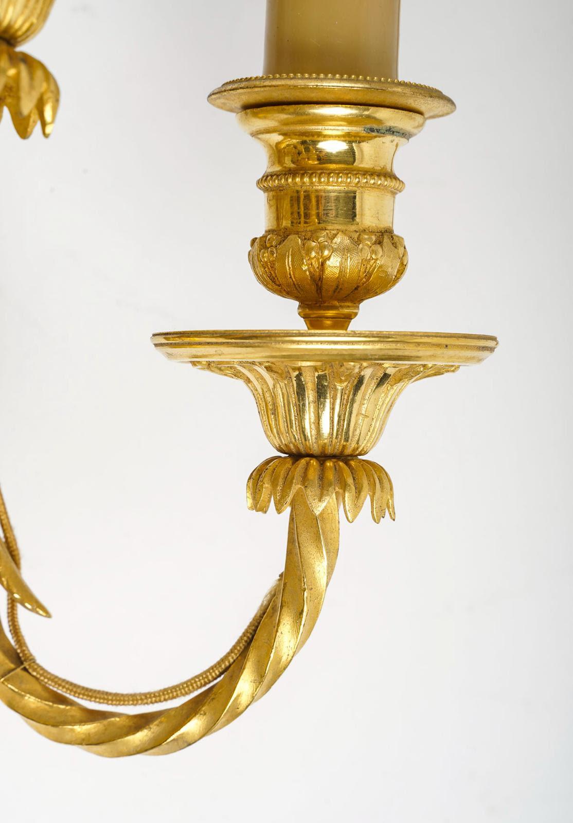 French Pair of Louis XVI Style Wall Lights in Chased and Gilt Bronze.