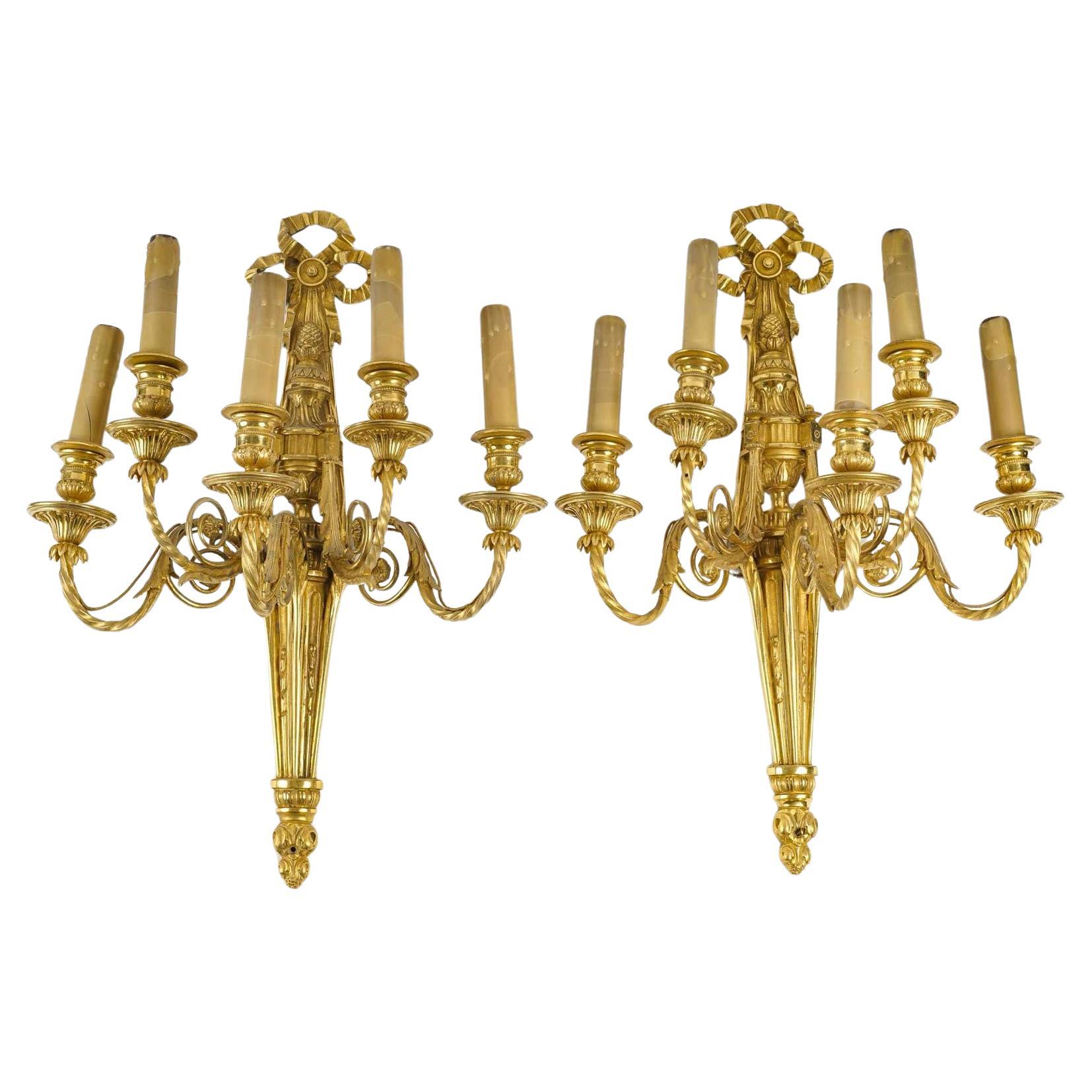 Pair of Louis XVI Style Wall Lights in Chased and Gilt Bronze.