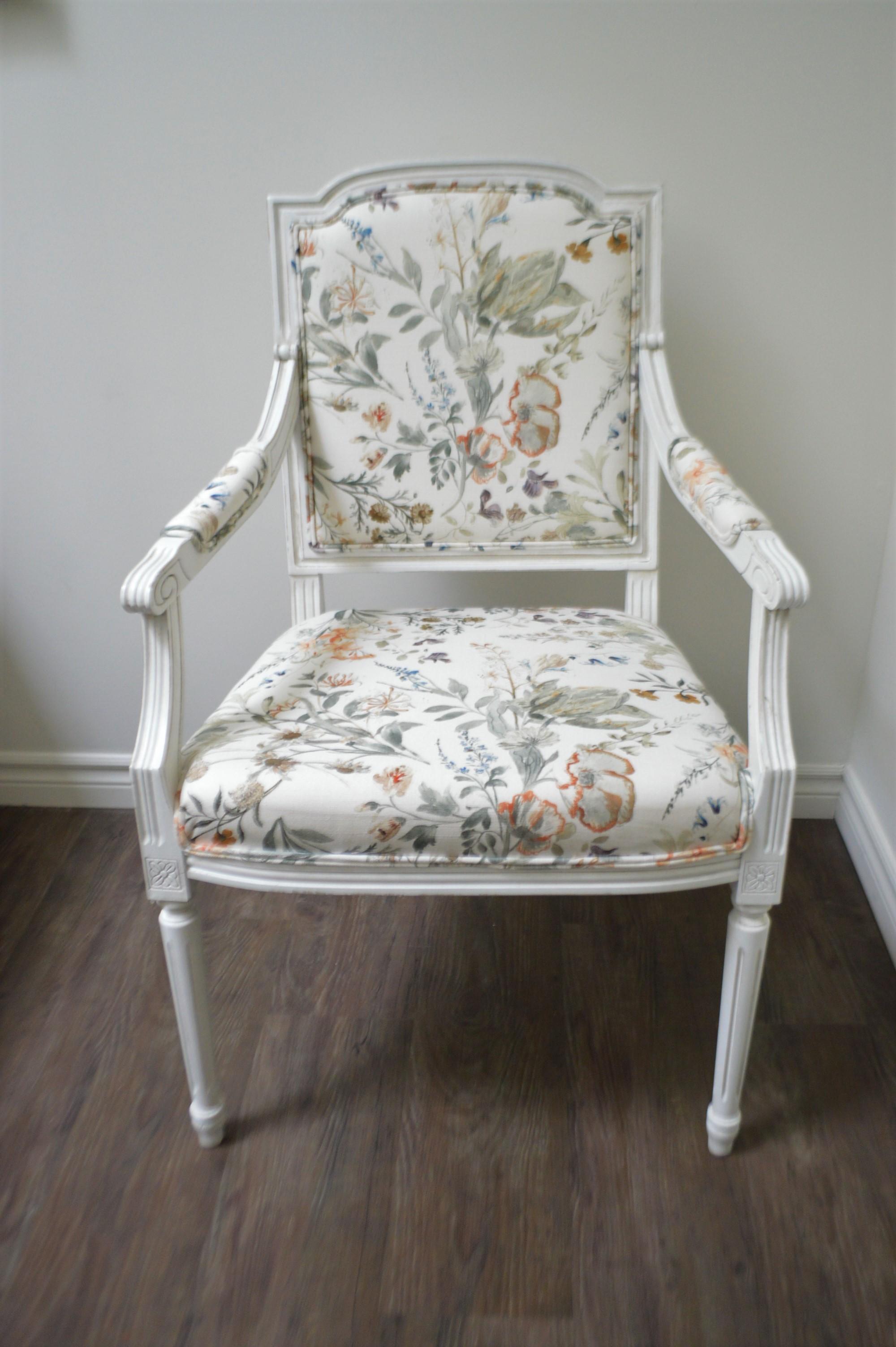 Pair of Louis XVI style, paint white and a light distress finish. The fabric is very fresh, white background floral in light and dark grey, apricot and some dark blue.
The size of the armchairs is generous.