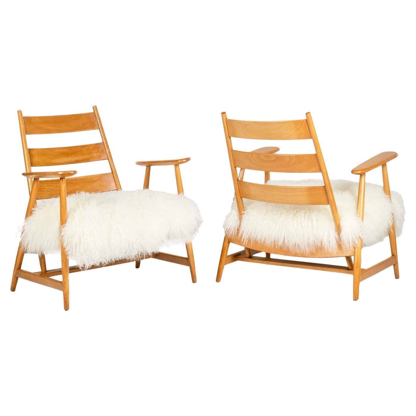Pair of “lounge” armchairs in blond beech. 1950s