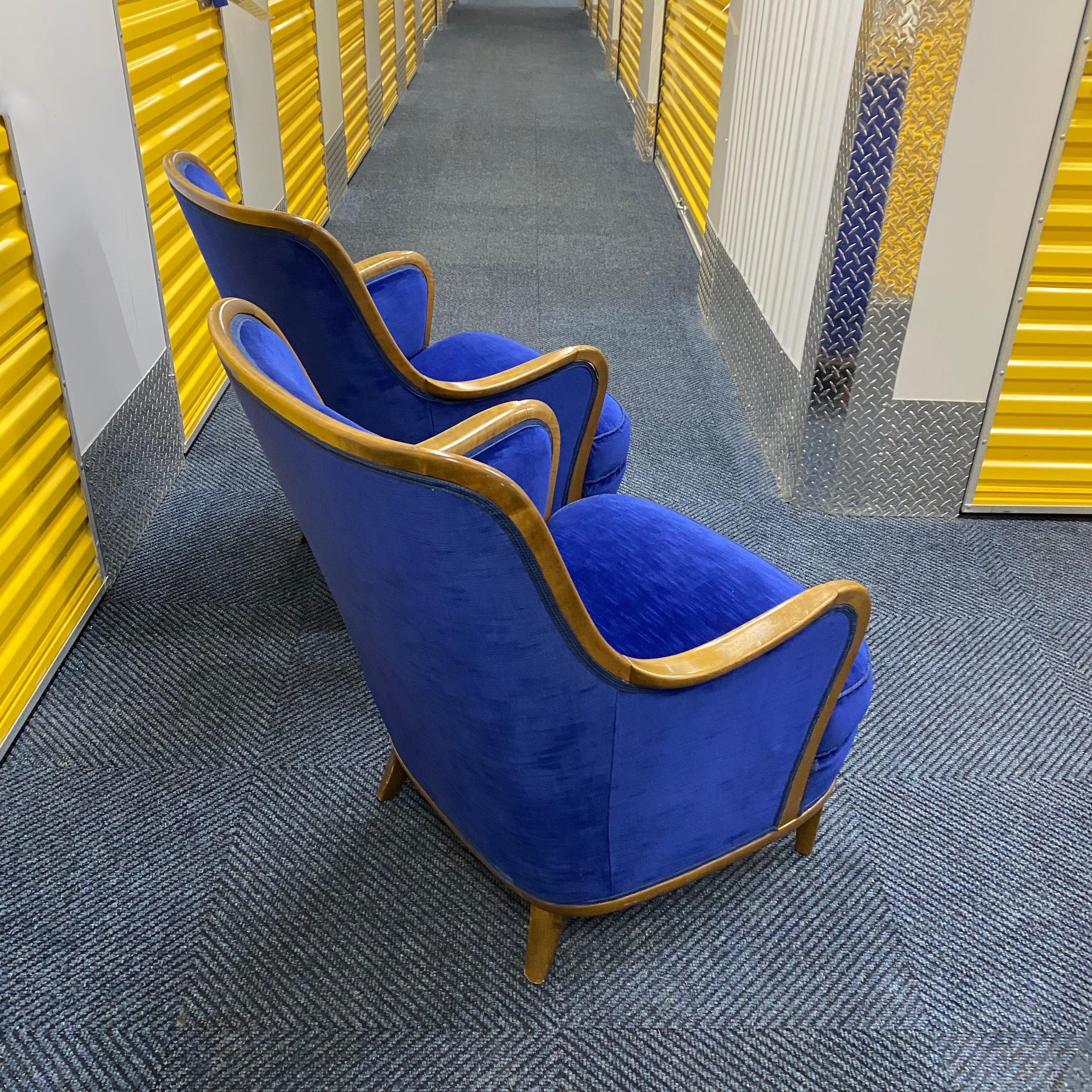Pair of Lounge chairs attributed to Axel Larsson. Manufactured around the 1940s in Sweden. Beautiful curvy wooden edges currently upholstered in a blue fabric.

Frames are sold in their current condition and fabric in need of re-upholstery. Please