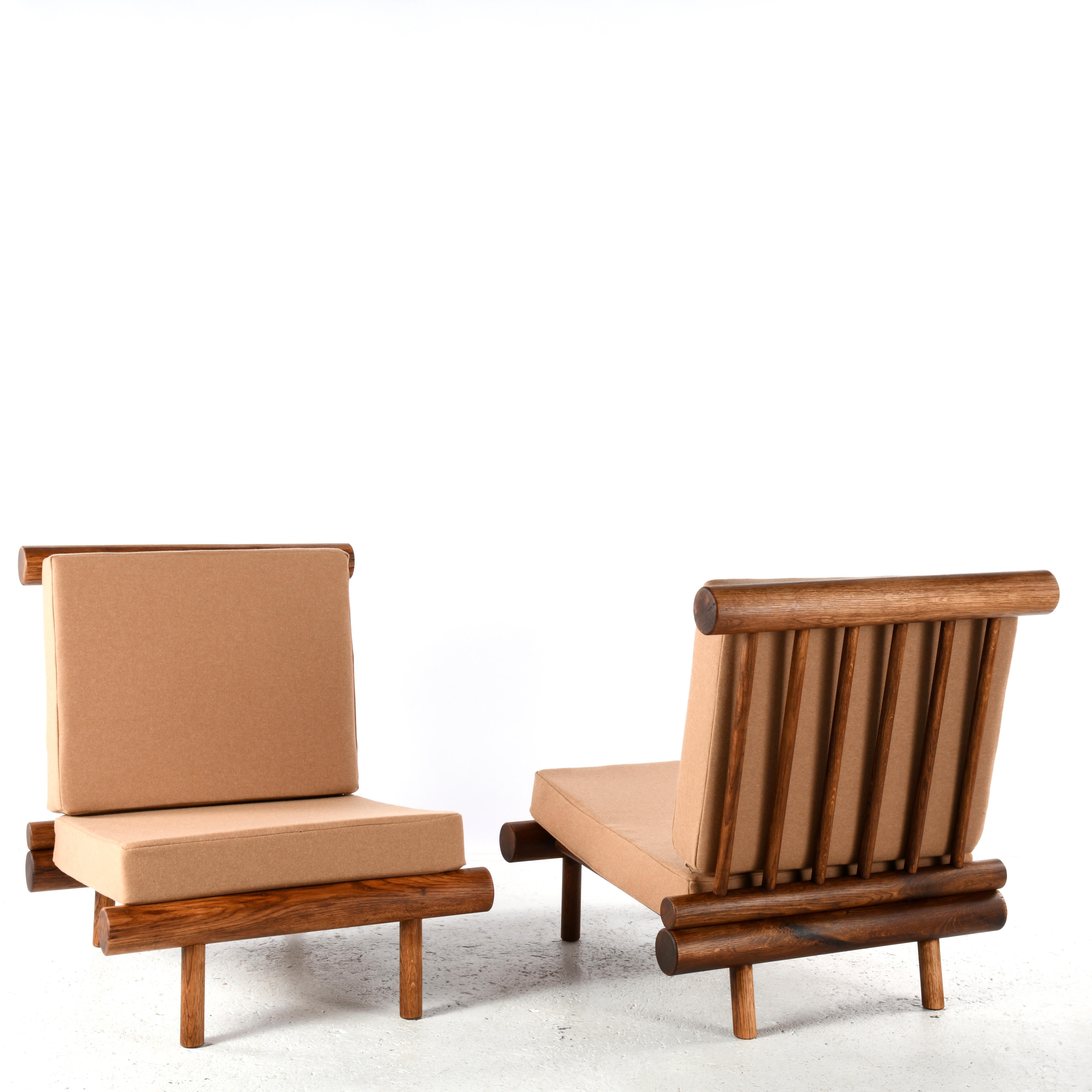 Pair of oak fireside chairs attributed to Charlotte Perriand. These chairs come from the La Cachette residence, located in the Les Arcs 1600 ski resort in the French Alps. Charlotte Perriand, the famous French architect and designer, directed the