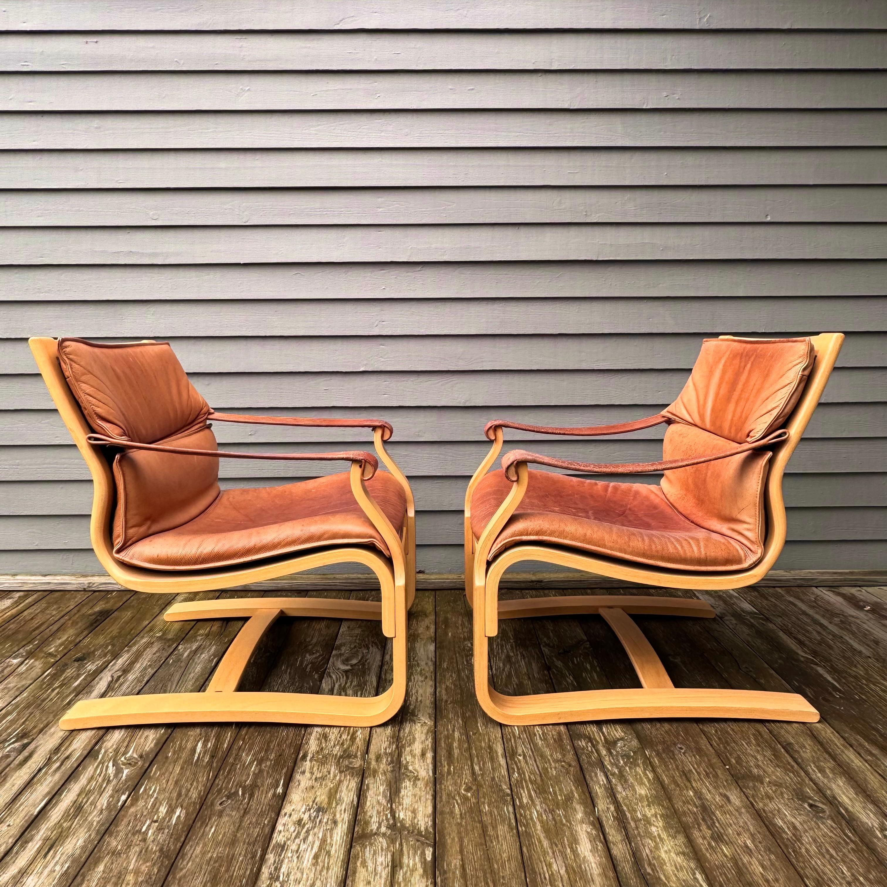 A pair of lounge chairs by Åke Fribytter. The chairs have lovely patina and has a nice swing when seated on, 